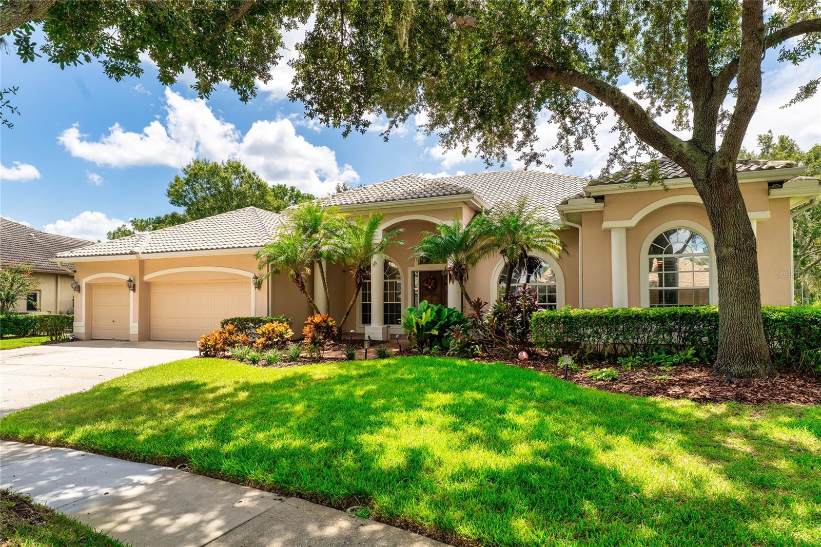 Welcome to this elegant residence in the highly sought-after Osprey Pointe at Hunter’s Green community, where timeless architecture and modern comforts come together. A stately double-door entry opens to soaring ceilings, crown molding, and expansive windows that bathe the home in natural light. Formal living and dining spaces set the stage for entertaining, while the chef’s kitchen, complete with granite counters, custom cabinetry, and a generous center island, flows seamlessly into the family room with tranquil pool views.
The owner’s suite is a private retreat with a spa-inspired bath featuring dual vanities, a garden tub, and walk-in shower. Additional bedrooms, a flexible office/den, and well-designed guest accommodations provide comfort and versatility.
Step outside to your personal sanctuary: a screened lanai with sparkling pool, lush landscaping, and a spacious yard ideal for gatherings or quiet evenings. With tree-lined streets, 24-hour security, and access to community amenities including golf, tennis, parks, and clubhouse, this home offers the best of Florida living in one of Tampa’s premier neighborhoods. Seller is offering a $10,000 closing credit towards paint and/or carpeting.