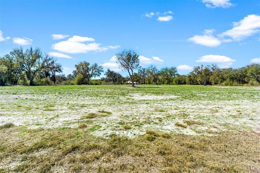 Discover the perfect canvas for your dream home on this stunning 5-acre parcel ideally located just minutes from the  amenities of The Villages. If you’ve been searching for space without sacrificing convenience then this exceptional property delivers it all. Beautiful mature trees have been thoughtfully trimmed. The lot itself is cleared and ready to build, saving you time and expense so you can move forward with your vision right away. The combination of open space and established trees creates a picturesque backdrop ideal for a custom estate home. Pride of ownership is evident throughout, with high-end custom residences being built at this time setting the tone for quality and architectural excellence. Bring your own builder and design the home you’ve always imagined — whether that’s a modern farmhouse, timeless traditional estate, or a sleek contemporary retreat with five full acres there’s ample room. Opportunities like this are rare — cleared acreage, premium location, and surrounded by beautiful homes. Secure your slice of Florida paradise today and start building the lifestyle you deserve. Your dream home begins here.