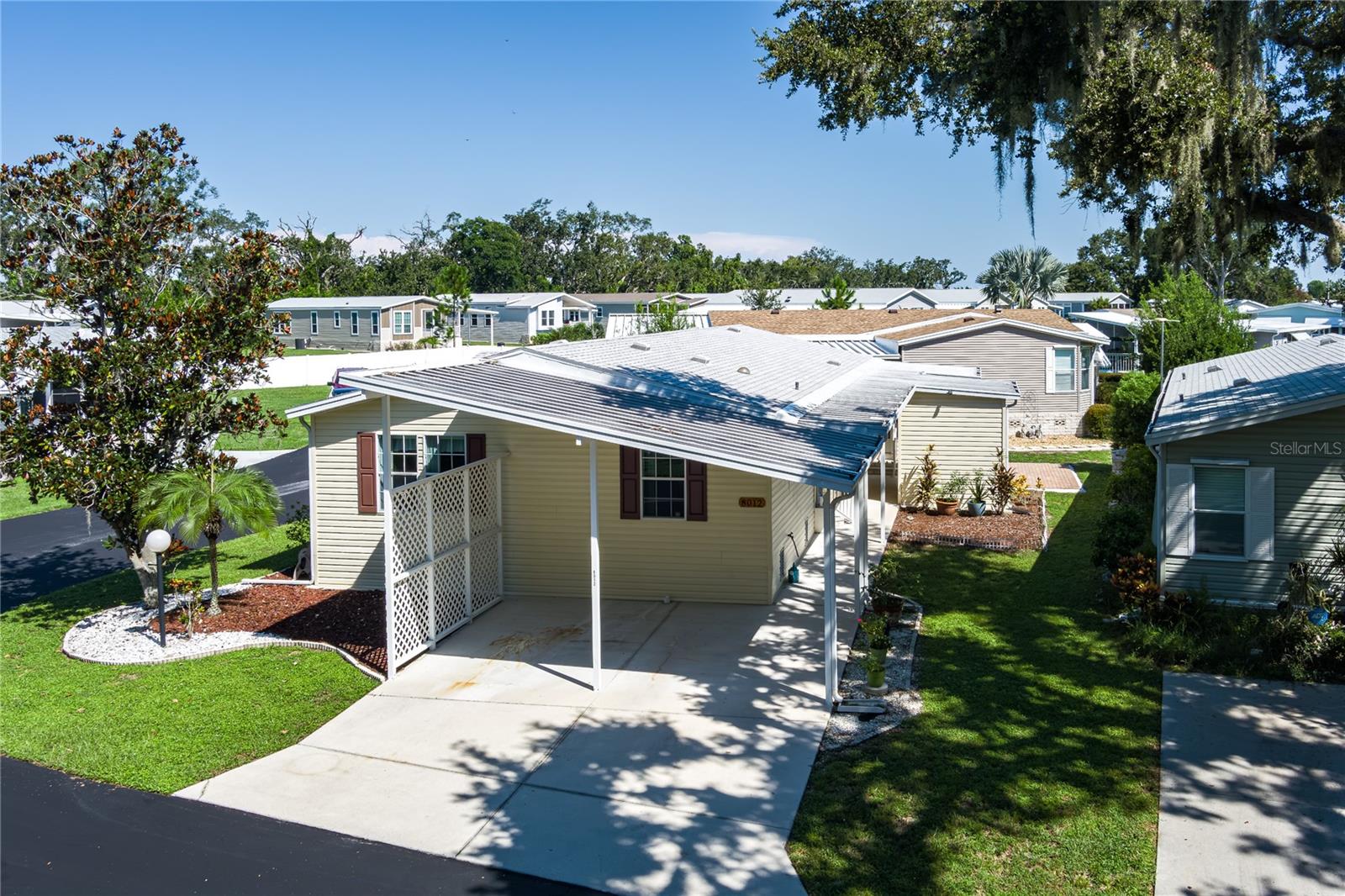 Welcome to your dream home in the highly sought-after 55+ co-op community of Terra Siesta! This spacious and beautifully maintained pet friendly 3-bedroom, 2-bathroom residence features just under 1,500 square feet of living space with soaring vaulted ceilings, 2-car covered car port, and an abundance of natural light. Also located on a dead-end street. Newer water heater 2025, shingle roof 2019. Situated on a large corner lot with serene water views of a tranquil pond from the enclosed lanai or outdoor patio, this turn-key home is ready for you to move right in. Enjoy the peace of mind that comes with being in a non-flood zone, while still enjoying picturesque surroundings. The HOA fee of just $174/month includes sewer, trash, and access to a wide array of amenities — including two heated pools, pickleball courts, tennis, shuffleboard, two clubhouses, bingo nights, and numerous other social activities. Centrally located near I-75, this home is also just minutes from top-rated restaurants, shopping, and everything the Suncoast has to enjoy. Whether you're seeking an active lifestyle or a quiet retreat, this Terra Siesta gem truly provides it all.