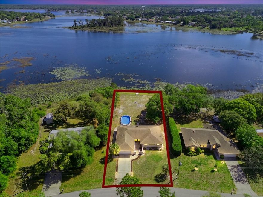 One or more photo(s) has been virtually staged. Welcome to your new Lake House on the shores of Lake Dupont! NO HOA! Enjoy sweeping lake views on a half-acre lot from this impressive 4-bedroom Deltona home. From the moment you walk in, you’ll feel right at home. The remodeled kitchen features 36-inch soft-close custom cabinetry, granite countertops, and stainless-steel appliances. The living room offers a warm and inviting atmosphere with a wood-burning fireplace and double French doors that open to the outdoors. The primary suite provides generous closet space, a beautifully remodeled private bathroom, and picturesque views of the lake. The additional bedrooms are spacious and share an updated guest bathroom. Just off the living room, a bright 4th bedroom offers the perfect flex space—ideal for an office, reading nook, or game room. Step through the French doors to discover an open patio, a sparkling blue pool, and panoramic lake scenery that creates a true backyard retreat. The property sits on over half an acre of cleared, versatile land, offering endless possibilities for outdoor enjoyment. Additional features include a NEWER roof, electrical panel, gutters, ceramic tile throughout, and RV/boat parking. All of this in a convenient Deltona location close to shopping, dining, parks, and major roadways. Lake Dupont in Deltona is a scenic, quiet freshwater lake known for its beautiful sunsets, calm water, and popular fishing. It’s one of Deltona’s more peaceful natural spots, surrounded by greenery and used mostly for low-key recreation.  Unbeatable location, just minutes to I-4, shopping, dining, and under 40 minutes to Orlando and the beaches.