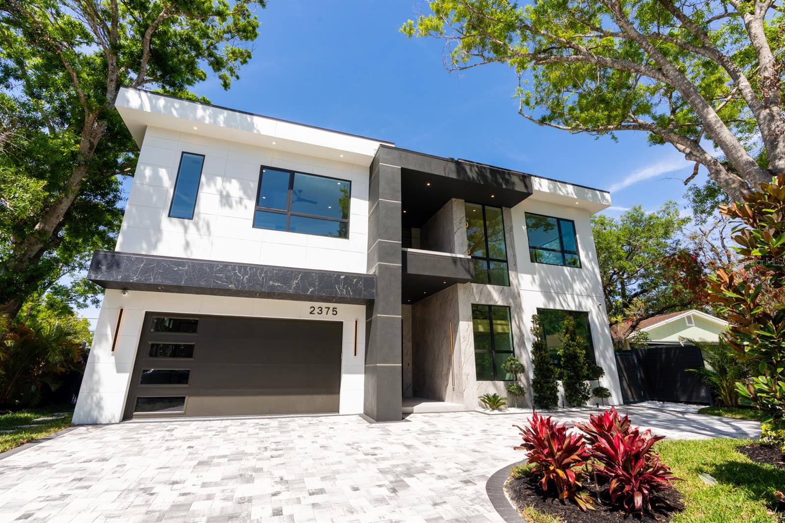 Luxurious New Build in Sarasota: A 5-Bedroom Haven Close to Siesta Key!
Indulge in the epitome of upscale living in this newly constructed 5-bedroom, 6-bathroom masterpiece, ideally situated near Siesta Key and the vibrant heart of Downtown Sarasota. This exquisite home offers a harmonious blend of elegance and comfort, designed for those who cherish a high-end, yet comfortable lifestyle. Step inside your personal sanctuary where a private, heated swimming pool is enhanced by a stunning tall waterfall feature, creating a resort-style ambiance that invites relaxation and leisure. The beautifully designed outdoor spaces, complete with an elegant dining setup and serene balcony on the upper level., provide idyllic settings for savoring the balmy Florida breezes. The home's interior is a testament to refined living with an open-plan design that allows for an effortless flow between the living, dining, and kitchen areas. The state-of-the-art chef’s kitchen is a centerpiece, featuring a custom-designed island with an extended countertop and seating area, perfect for casual dining or upscale entertaining. Equipped with top-tier appliances, expansive countertops, and sleek cabinetry, this kitchen is both beautiful and functional. For those who work from home, the dedicated office space is an absolute delight, boasting a built-in desk and cabinetry. This well-appointed area ensures productivity and comfort, blending seamlessly with the rest of the home's luxurious aesthetics. Accommodations include five generously sized bedrooms, each creating a private oasis. The lavish master suite and additional bedrooms are meticulously appointed, ensuring every comfort is met with luxury. Located just a short drive from the renowned Siesta Key Beach, this property offers access to the exquisite sandy beaches and crystal-clear waters, along with proximity to Siesta Key Village’s array of boutique shops, gourmet restaurants, and lively entertainment options.
Seize the chance to make this luxurious haven your own and experience a blend of relaxation and sophistication like never before. Schedule your exclusive tour today and step into a lifestyle redefined.
