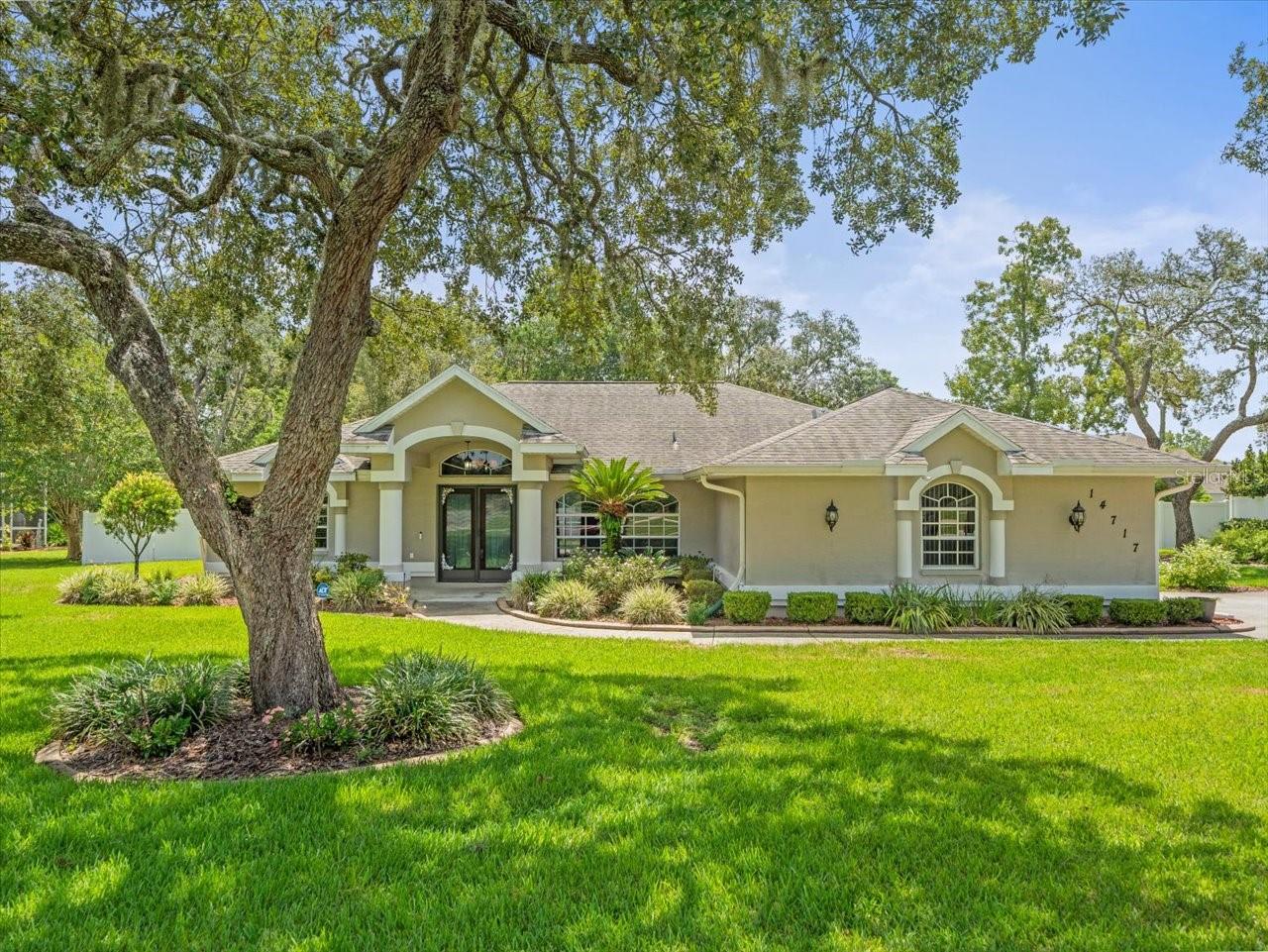 Are you looking for a truly move in ready pool home? Where should I begin with this beautiful home, the upgraded kitchen with soft close cabinets, the updated primary bathroom with custom cabinetry, or the salt water pool with a waterfall? This 3 bedroom, 2 bathroom home offers a split floorplan with updates throughout. As you enter the double front doors, you are greeted with a living room and dining area with luxury vinyl flooring. The primary bedroom is on the left through a set of French doors and has 2 walk in closets. The primary bathroom has been updated with a large walk in shower, double vanity, with floor to ceiling side cabinets. The upgraded kitchen offers soft close solid wood cabinets with granite countertops and stainless steel appliances. Both guest bedrooms offer built in closets and new light flooring. Through the sliding glass doors you have a screened in salt water pool with a waterfall feature. The pavered patio area also covered area with a small cooking area. The backyard is completely fenced in with vinyl fencing and a shed for extra storage. This home has a new water softener as well. This home is minutes from a nearby Publix, plus ease of access to the Suncaost Parkway for connections to the greater Tampa area.