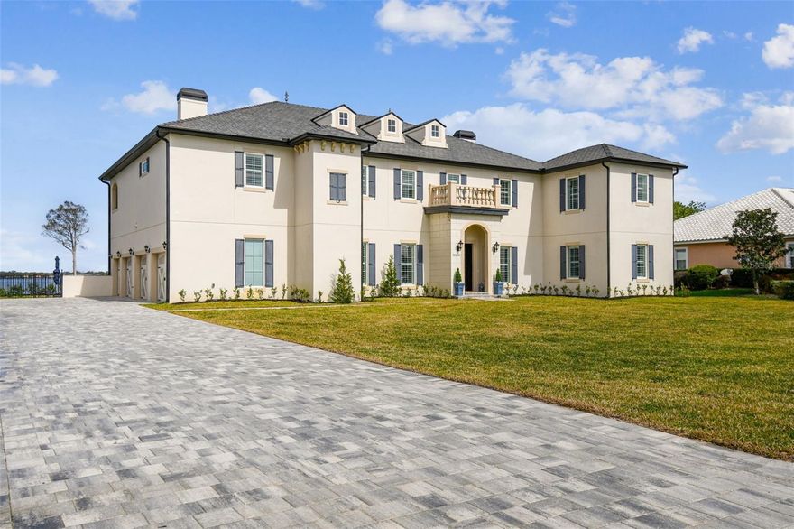 Experience unmatched luxury in this extraordinary estate perched on a private peninsula surrounded by shimmering lake views and an elite golf course within the gated community of Deer Island. Deer Island is renowned for its world-class golf course and seamless blend of lakefront living with 185 feet of waterfrontage on Harris Chain of Lakes. This one-of-a-kind estate offers a lifestyle of tranquil mornings, sunset cruises and tee times just steps from your front door. On Lake Dora, the home exudes the timeless elegance of a French countryside custom-built estate. This stunning home with hydraulic elevator features six bedrooms, 5.5 baths with home theater and two-story office with library, which spans 6,200 square feet, including an additional private 340-square-foot guest house with a separate entrance. Culinary enthusiasts will love the state-of-the-art kitchen, featuring Bosch dishwasher, a French door refrigerator, and three ZLINE ovens with a built-in butler's pantry with an additional refrigerator. Unlike standard roofing, this home boasts Brava Tile, engineered to withstand Category 5 hurricanes while enhancing energy efficiency and longevity with a lifespan of 50-plus years. Upstairs, a spacious home theater offers the ideal entertainment retreat, while well-appointed bedroom, each with a private en suite, ensure guests enjoy comfort and privacy. Step onto the upstairs balcony to take in breathtaking lake views, adding to the home’s serene and luxurious ambiance. Enjoy the Florida sunshine in your saltwater pool, surrounded by lush landscaping and private boat dock with boat cradle which holds two jet skis or a 24-foot boat. This lakefront oasis offers direct access to the Atlantic Ocean via the Chain of Lakes, making it a paradise for boating enthusiasts. Enjoy a leisurely three-minute boat ride to the hallmark town of Mount Dora, known for its boutiques, dining and festivals. With Lake Dora spanning 22 miles and Lake Eustis rich history of Hollywood film sets, this home blends luxury, privacy and adventure. Just a short drive from major Florida cities, yet tucked in a serene lakeside retreat, this estate is one of a kind. Don’t miss your chance to own this masterpiece and schedule your private tour today!
<iframe src="https://realestate.febreframeworks.com/videos/01952912-3e63-705c-9dea-d6aa635409b3" width="640" height="360" frameborder="0" allow="autoplay; fullscreen; picture-in-picture" allowfullscreen style="border: 0"></iframe>