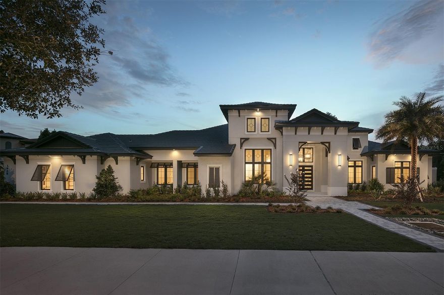 From the moment you arrive, this home makes a statement. Meticulous architectural details like rafter tails, handcrafted corbels, and a bell cast roof flare immediately set the tone for the craftsmanship within. Subtle soffit LED lighting and artfully placed landscape lighting create an evening ambiance that feels both welcoming and cinematic.

Step through the grand double doors and enter a space where every element has been thoughtfully curated. To your left, a formal dining room glows with natural light from expansive front-facing windows. A striking feature wall, adorned with elegant mirrors, leads your gaze to the temperature-controlled wine room—clad in modern stacked stone with floating glass wine displays that blur the line between function and art.

The nearby powder room is a design moment in itself, featuring a chevron accent wall and Restoration Hardware vanity. Just beyond, the private office showcases custom built-ins and dual barn doors that open directly to the pool and lanai.

In the great room, 14-foot ceilings soar overhead, finished with tongue-and-groove paneling and painted wood beams for an airy yet grounded feel. The chef’s kitchen is a dream realized, complete with a waterfall island, bespoke hood, and premium Wolf and Sub-Zero appliances—including a 48” cooktop with six burners, griddle, and double ovens. Floating ceilings with modern track lighting and a hidden pantry with custom shelving round out the space.

The game room is built for both play and entertainment, functioning as a movie theater and billiards lounge with massive cornerless sliders that open to a 2,000-square-foot covered lanai. Equipped with a summer kitchen, fireplace, and power screens for privacy, this outdoor retreat blurs the line between indoors and out.

Your primary suite is a sanctuary of sophistication. Generously sized and bathed in natural light, it opens directly to the pool area. A built-in breakfast bar with Meile coffee system and sink brings café-level comfort to your morning routine—no slippers required. The ensuite bath rivals a luxury spa with floating vanities, oversized porcelain tile, soaking tub, and a spacious walk-in shower that extends to a private outdoor shower surrounded by a privacy wall. The expansive custom closet with tall ceilings offers both elegance and organization.

Outside, the backyard is designed for leisure and connection. A sparkling pool with sun shelf, built-in hot tub, and cozy fire pit invite relaxation, while the lush surroundings offer space to breathe and play.

Completing this incredible estate is a 1,100-square-foot guest casita—ideal for long-term guests or multigenerational living. With a living area, kitchenette, large bedroom, and walk-in shower, it's a fully equipped retreat overlooking mature oaks and vibrant landscaping.
Smart home features abound, including over $200,000 in integrated audio/video systems, motorized shades, and custom drapery—all seamlessly controlled at your fingertips.

This is more than a home—it’s a statement of style, comfort, and intention. Come experience the lifestyle you’ve always imagined.