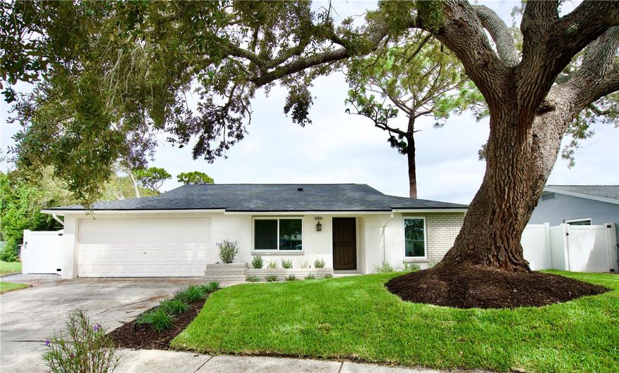 Step inside this fully renovated 3-bedroom, 2-bathroom block home tucked away at the end of a quiet cul-de-sac in one of Largo’s most charming, family-friendly neighborhoods. Every inch of this home has been thoughtfully updated with high-end finishes and modern convenience in mind — truly move-in ready.
Enjoy immediate peace of mind with brand-new PGT impact-rated windows throughout the home, providing exceptional hurricane protection, energy efficiency, and sound insulation, keeping your home safe and quiet year-round. They come with a 25-year transferable warranty, giving you long-term confidence and savings on insurance premiums, an incredible benefit for Florida homeowners.
The home’s interior showcases brand-new water-proof luxury vinyl plank flooring, fresh interior and exterior paint, and all-new fixtures and modern lighting. Both bathrooms have been completely redesigned with porcelain and marble tile, new vanities, upgraded DELTA plumbing fixtures, and elegant finishes. 
The designer kitchen features new Samsung stainless steel appliances, Carrara Viola quartz countertops, all-new cabinetry, and a large kitchen island with seating for casual dining. A separate formal dining area offers space for larger gatherings or holiday meals, while the open-concept living room features high vaulted ceilings and a charming wood-burning fireplace, the perfect focal point for cozy evenings or entertaining guests.
Roof: Brand-new shingle roof installed in 2025 with a transferable 25 year warranty. 
Electrical: Entire electrical system upgraded, including a new panel, updated wiring, outlets, and switches.
Plumbing: Brand new water heater and all plumbing fixtures and valves have been replaced. Bathrooms, kitchen, and laundry connections are in excellent working order with no leaks or corrosion.
HVAC: Central A/C system replaced in 2018 and recently enhanced with all-new ductwork and insulation. 
Together, these improvements make the home energy efficient resulting in energy cost savings as well as insurance-ready, helping to save on premiums. 
The property exterior features brand-new landscaping with fresh sod, a new irrigation system and well pump on relay, and a brand new vinyl fenced yard, perfect for pets, family, or outdoor entertaining. The two-car garage provides ample storage and parking, while the solid concrete-block construction and new roof and windows deliver long-term durability and peace of mind.
From the curb appeal to the finishes, every detail has been thoughtfully redone — making this home not just renovated, but rebuilt for modern living. Enjoy the perfect balance of design, efficiency, and security in this hurricane-ready, move-in-ready Largo home where every major system and surface is brand new. One or more photos have been virtually staged.