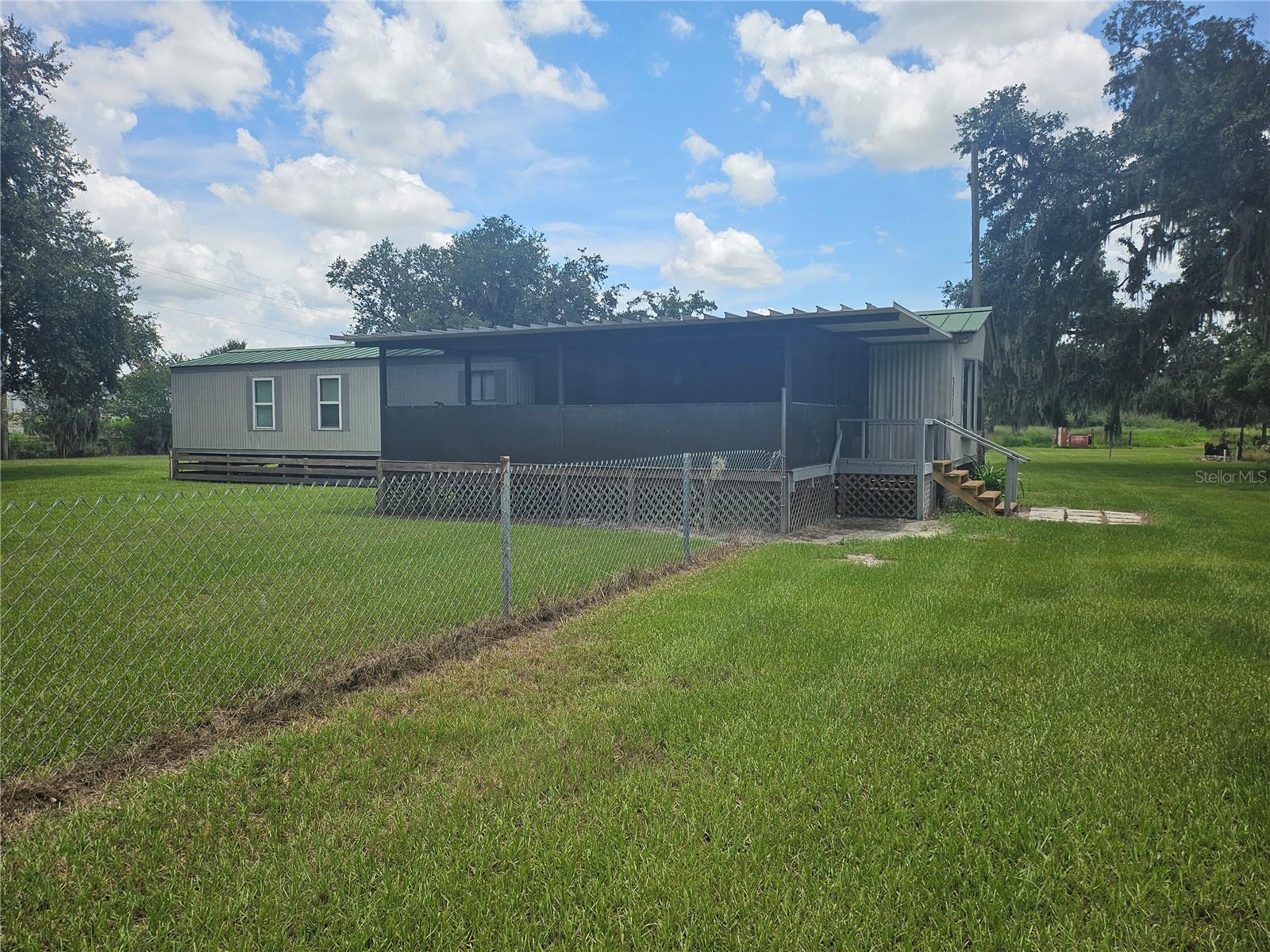 Paradise! Nice 2 bedroom 2 bath mobile home on a beautiful 3/4 acre parcel. The home has new carpet in the living room and both bedrooms. There is a large front screen enclosed front deck porch, part of the front yard has chain link fencing leaving a large side yard and backyard. Pretty tree shaded lot making it a quiet paradise to enjoy!