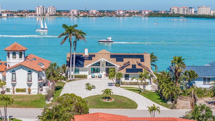 Luxurious and easy living in a STUNNING WATERFRONT RETREAT awaits you on the ISLAND PARADISE OF TIERRA VERDE. 
Upon entering this BEAUTIFULLY UPDATED, ONE-LEVEL CONTEMPORARY RESIDENCE, you will be mesmerized by the wall of floor-to-ceiling windows that bring the sparkling aqua waters of Boca Ciega Bay right into the room. Relax and enjoy the spectacular view as boats cruise slowly by in the channel’s no-wake zone, and be entertained as dolphins fish, frolic and play just a short distance away from the recently constructed dock and 85-ft seawall. The spacious, open concept Great Room with a vaulted volume ceiling is a major WOW-FACTOR, OFFERING WIDE-ANGLE VIEWS TO THE COASTAL OUTDOORS and endless opportunities for entertaining family and friends. Adjacent to the Great Room is a sleek and stylish kitchen, with Shaker soft-close cabinets, an induction range, convection oven and microwave, French Door stainless refrigerator and wine fridge. Soft gray veined Calacatta quartz countertops are complemented by a sea pearl mosaic backsplash, extending over a peninsula that provides ample seating for guests as well as extra storage space. A walk-in pantry provides additional storage space with built-in shelves and cabinetry.

Combining an elegant living space that blends outdoor and indoor living with one of the most elevated waterfront lots on the island, you can rest assured that you are high and dry. NEW PGT hurricane-impact windows, sliders and doors and a fully-owned solar heating and cooling system keeps electric bills at $30/month, and gives you added peace of mind. Other upgrades in include a 3-ton variable speed heat pump/return from main area, a new pool pump and a retractable solar pool cover.

The split floor plan features a primary retreat with a volume ceiling, loft storage area, and sliders leading out to an elevated private patio looking across to the Tierra Verde bridge, where you can greet the inspiring daily sunrises with your morning cup of coffee. The primary bath has a spa-like ambiance with porcelain tile, elegant, modern floating sinks, and a super shower with a double rain head shower system and built-in bench. Two other bedrooms on the opposite side of the home, one with a Murphy Bed, provide a separate private guest wing, with a shared modern updated bath, tub and shower.

Outside, enjoy the coastal breezes and wide-water views from an expansive 2-level patio, or while taking a dip in the solar-heated pool and spa. A newly constructed outdoor grilling nook lets you dine outdoors into the evening as the sun sets over the famous Don CeSar Hotel to the west. Boaters can cruise east through the Pinellas Bayway Tierra Verde Bridge to Tampa Bay … and to the west with direct unobstructed access via Pass-a-Grille Channel out to the Gulf.

The island paradise of Tiera Verde is just off the beaten path from the local tourist scene, but with easy access to everywhere! It’s only  30-40 MINUTES FROM 2 INTERNATIONAL AIRPORTS VIA I-275 and 10 minutes to downtown St. Pete with its cultural attractions, entertainment venues, Saturday Morning Market and top-rated restaurants. Best of all, you are within minutes of the area’s sought-after Gulf beaches and award-winning Fort DeSoto, an 1100 acre park offering an array of sugar sand beaches, boat launches, fishing, camping, kayaking and miles of nature trails – all right in your backyard. Don’t miss the opportunity to schedule your showing today to tour this COASTAL DREAMHOUSE!