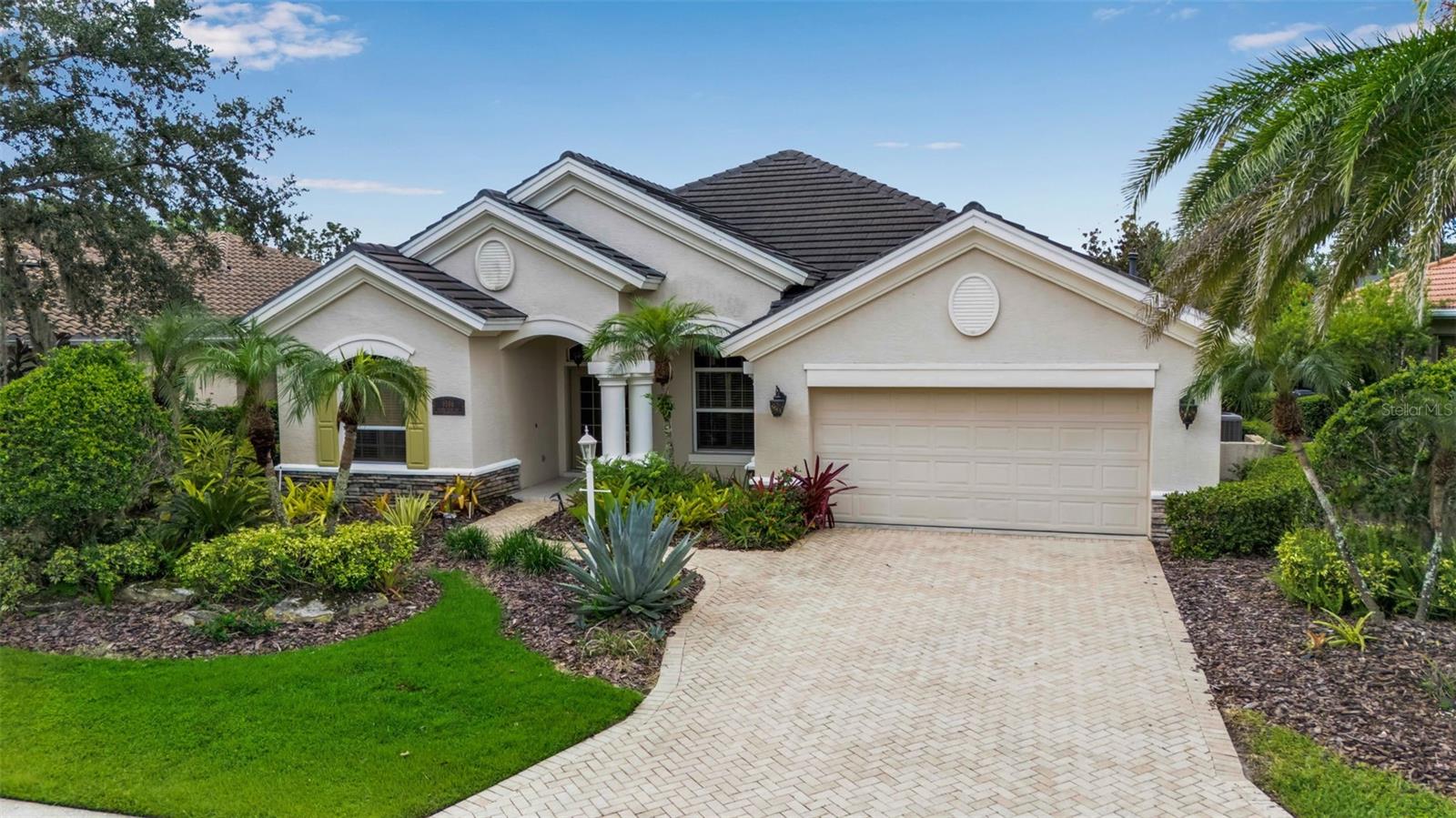 Experience the best of the Florida lifestyle in this elegant Lee Wetherington home located in the heart of Lakewood Ranch. With 4 bedrooms plus a den, this residence showcases timeless craftsmanship with hardwood and tile floors, plantation shutters, vaulted and tray ceilings, crown molding, artistic niches, and a split floor plan. The spacious owner's retreat includes dual vanities, marble counters, a walk-in linen closet, soaking tub, and separate shower. Guest accommodations feature an ensuite near the kitchen, a private walk-in closet bedroom, and a custom Murphy bed by Yoder that makes entertaining guests a breeze!
The gourmet kitchen offers Corian counters, natural gas stainless steel appliances, pullout cabinets, and a wet bar, while a dedicated office with beautiful hardwood floors provides an ideal workspace. Walls of glass and an aquarium window open to the lanai, where you’ll find a heated saltwater pool and spa—perfect for year-round entertaining.
Recent updates provide peace of mind: new HVAC, 2023 hot water heater, 2020 roof, and hurricane shutters. Additional highlights include a 2-car garage with cabinetry and lush curb appeal.
More than a home, this residence offers a gateway to Lakewood Ranch living, complete with world-class golf, wonderful amenities, and a true sense of community.
