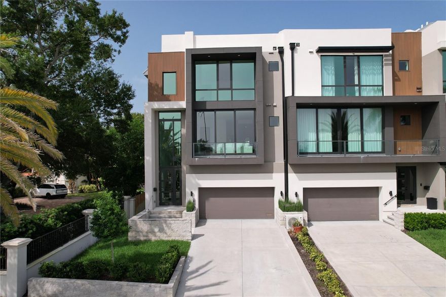 Welcome to 98 W Davis Blvd, a stunning luxury 5-story townhouse located on the prestigious Davis Island in Tampa, FL. This exceptional residence, built in 2022 and never before lived in, offers the epitome of modern elegance and convenience. Crafted as the final project by renowned designer Tommy Lamb, this townhouse showcases impeccable attention to detail and the latest in luxury living. As you step inside, you'll find a versatile bonus room on the first floor, complete with a wet bar, perfect for entertaining guests. Additionally, there is a spacious guest suite with an en-suite bathroom and a closet featuring custom built-ins. This en-suite bathroom also doubles as a convenient pool bathroom and features a makeup vanity. The second floor boasts a powder bathroom, a formal living room with a ventless fireplace, a formal dining room, a well-appointed kitchen, a comfortable family room, and a second guest suite. The kitchen is a chef's dream, featuring top-of-the-line Wolf appliances, a Sub-Zero refrigerator, a stunning waterfall island that can easily seat four people, and a captivating feature wall with the same quartz used for the countertops. The kitchen also offers two pantries and additional back cabinets, providing ample storage space. Adjacent to the family room, you'll find a wine room with a large window offering a glimpse of the floating staircase leading to the third floor. On the third floor, you'll discover another guest suite with a walk-in closet, a master suite with a private balcony, and a laundry room equipped with two sets of washers and dryers for added convenience. The master suite is a sanctuary of luxury, featuring a spacious walk-in closet with sleek black built-ins and elegant gold accents. The master en-suite bathroom offers his and her sinks, a standalone black tub for indulgent relaxation, and an oversized shower adorned with multiple shower heads. In addition to its luxurious features, the townhouse offers the convenience of an elevator, providing easy access to all five floors. This townhouse also includes a 2-car garage with ample space to accommodate a golf cart as well. Excitingly, Ryan Hughes Design has already been contracted to design the rooftop, balconies, and pool in the private backyard. The rooftop offers endless possibilities, with the option to create an outdoor kitchen, a hot tub, and adorn it with large potted plants, providing the perfect setting for outdoor entertaining and relaxation. Located on Davis Island, this residence offers a highly sought-after address, surrounded by scenic views and a vibrant community. Furthermore, families will be delighted to know that all schools serving this area are A-rated, ensuring an excellent education for children of all ages. With top-notch schools in close proximity, this residence offers an ideal setting for families seeking both luxury and educational opportunities. Don’t miss the opportunity to make this luxurious townhouse your dream home. Contact us today to schedule a private viewing and experience the pinnacle of modern living at 98 W Davis Blvd.