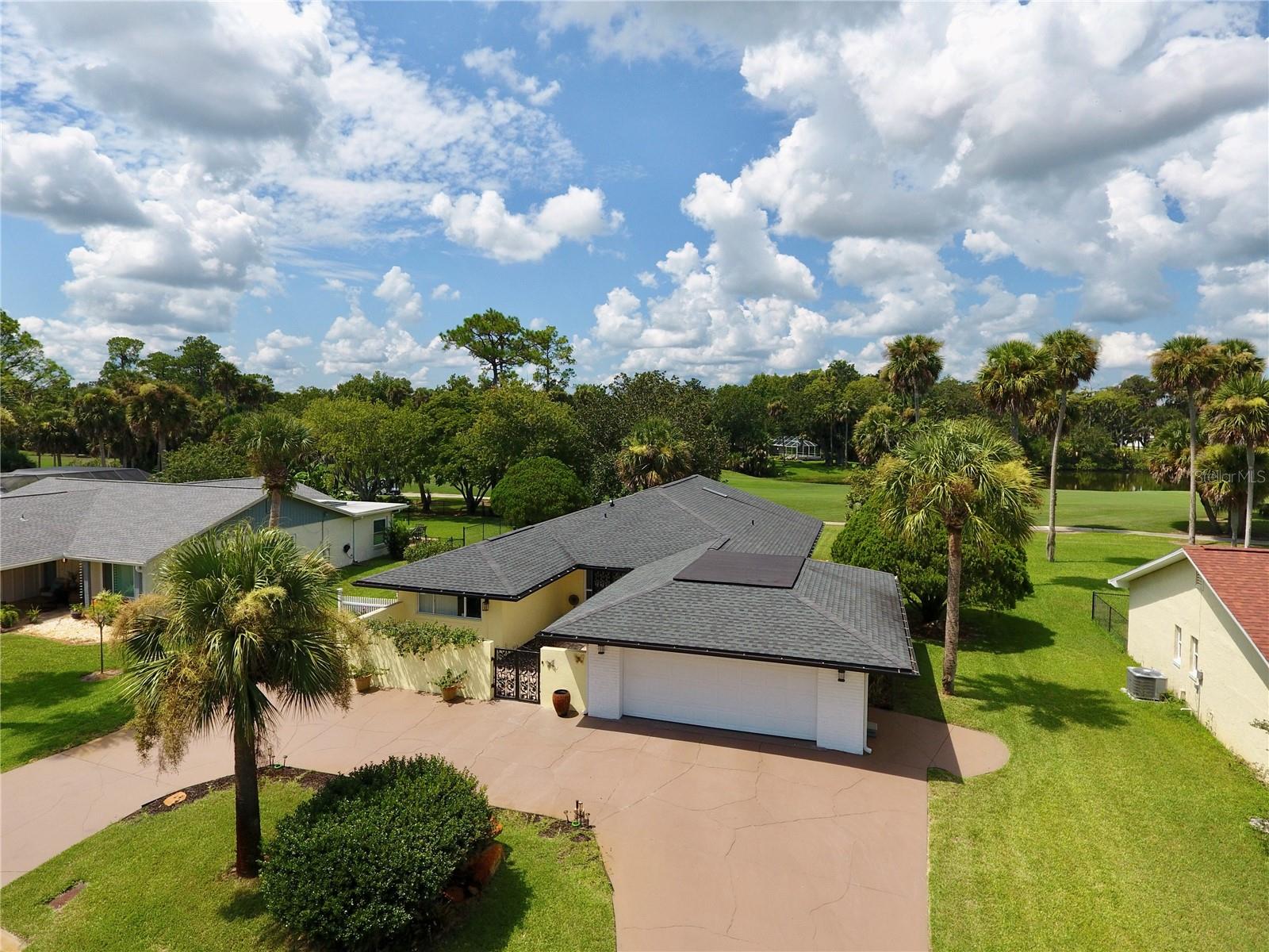 Rarely do houses like this come up for sale to own a stylish home backing up to the 13th tee of Palm Harbor Golf Club. Enter through custom wrought iron gates into a spacious courtyard—perfect for morning coffee. Inside, floor-to-ceiling windows and skylights offer stunning 180° views of the course and old oaks with water view.
Built by Levitt/ITT, this is a 1900 sq foot 2-bed, 2-bath home which blends vintage charm with modern updates. Highlights include:
Open floor plan with white tile and laminate floors, remodeled bathrooms with double vanities, stylish gray-and-white kitchen cabinets, ample closets and storage. Large lot with mature landscaping, oversized double garage with electric hurricane rated garage doors (110)
No HOA.
Close to European Village, Intracoastal Waterway, trails, shops, dining, and medical care.
This is a prime Palm Coast location!
Roof (11/2022) with oversized seamless gutters
Water heater (2022)
AC (4/2022)
Electric Panel 6/2025
4 zone irrigation system
Pavers that surround the house
