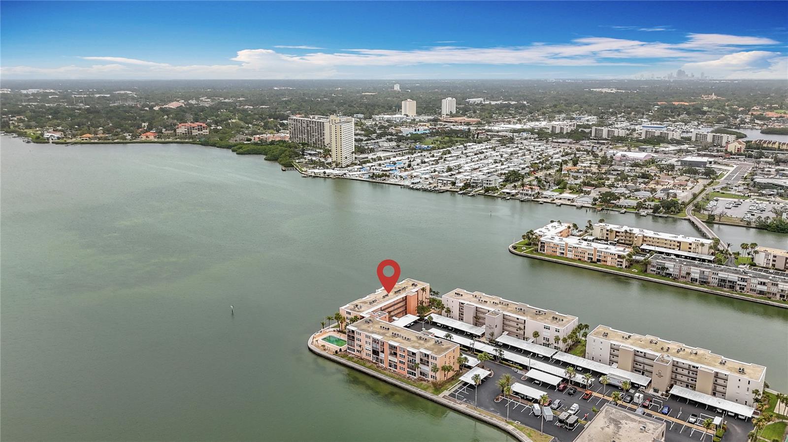 Rare 3-Bedroom CornerUnit Waterfront Gem in Bay Island! Welcome to Unit 206 at 7665 Sun Island Dr. S – a truly exceptional opportunity in the sought-after Bay Island community. This spacious 3-bedroom, 2-bath condo is a rare find in this complex, offering an incredibly hard-to-find floor plan with generous living space and stunning open water views that will take your breath away. Wake up to shimmering bay views and enjoy sunsets from your private balcony, perfectly positioned to capture wide-open vistas of Boca Ciega Bay. Natural light floods the living and dining areas, enhancing the airy, coastal feel of this one-of-a-kind residence. This unit is updated and move-in ready and is coming partially furnished. This unit offers a covered parking space right in front of the building and has a stackable washer and dryer right in the unit. The floor plan is a split plan with the primary ensuite bedroom overlooking the water and the other 2 bedrooms in the front of the condo. One thing that the Essex building offers that is unique to only this building is a workshop for the Essex owners to use. This is a great asset for this building. Bay Island is a gated 55+ community featuring resort-style amenities including multiple pools, tennis courts, clubhouse, fitness center, marina, and more – all just minutes from the beaches, shopping, and dining. If you’ve been waiting for a spacious waterfront condo with views, location, and unmatched potential – this is it. Don’t miss out on one of the few 3-bedroom units ever available in this premier community!