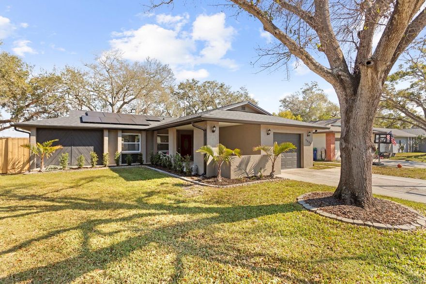 Welcome to this well-maintained and thoughtfully updated 2-bedroom, 2-bath, single-story home located in Bonnie Glynn’s deed-restricted community, featuring a 1-car garage and inviting front porch entry. The split floor plan offers privacy and functionality, with tile flooring throughout for easy maintenance and a clean, cohesive look. Major improvements include a brand-new roof (2025) with hurricane clips, which may help reduce insurance costs, along with solar panels installed in 2022 that will be paid off in full by the seller at closing—a significant value and energy savings for the new owner. With the paid-off solar system, the current owner reports approximately $30/month electric bills with Duke Energy. Additional updates include an A/C system approximately 5 years old and a water heater replaced 2–3 years ago. Enjoy Florida living in the HUGE fenced backyard, complete with a screened-in patio perfect for relaxing or entertaining. The spacious primary suite features a walk-in closet, and newer windows and sliding glass doors provide abundant natural light and easy access to the backyard. Conveniently and centrally located, this rare one-story home offers comfort, efficiency, and peace of mind with major systems already updated. Move-in ready and a must-see!