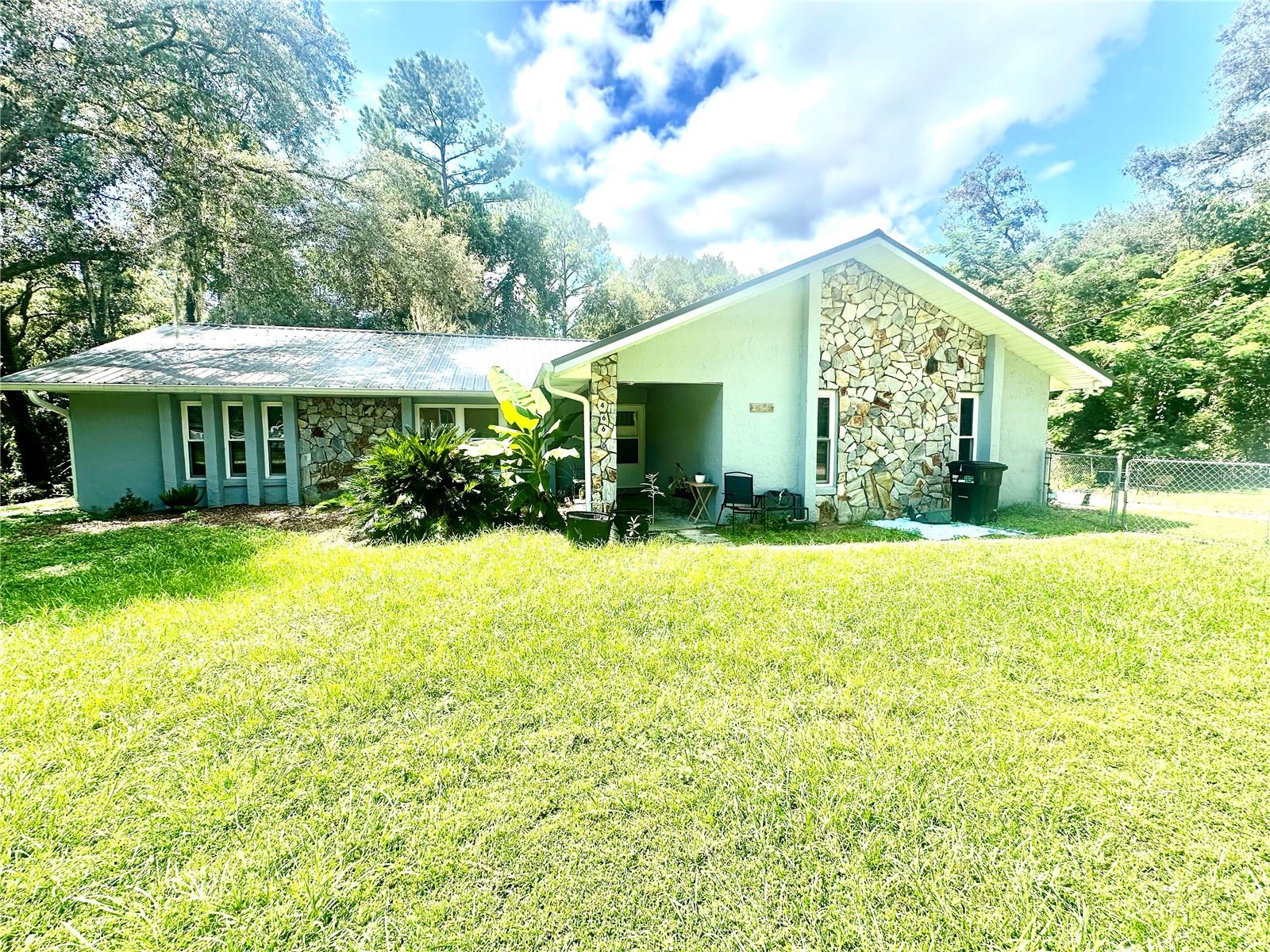 Great 3-bedroom, 2 bathroom home. Nestled on .37 of an acre fenced in yard. Home is surrounded by the Ocala National Forest. Open concept, split floor plan home with vaulted ceilings. Wood laminate flooring throughout. NO CARPET. Primary bedroom has a large walk-in closet , an ensuite with single vanity and shower. On the other side of home, you will find two spacious bedrooms. Open kitchen with a view to the backyard. Inside laundry room with washer/dryer hook ups. Inside the garage you will find a small room that could have many purposes. (NO heat or air) At the end of your day relax on the beautiful back screened in porch overlooking the wooded area. Fenced in backyard for your pets. Small storage shed also. Call today for your showing.