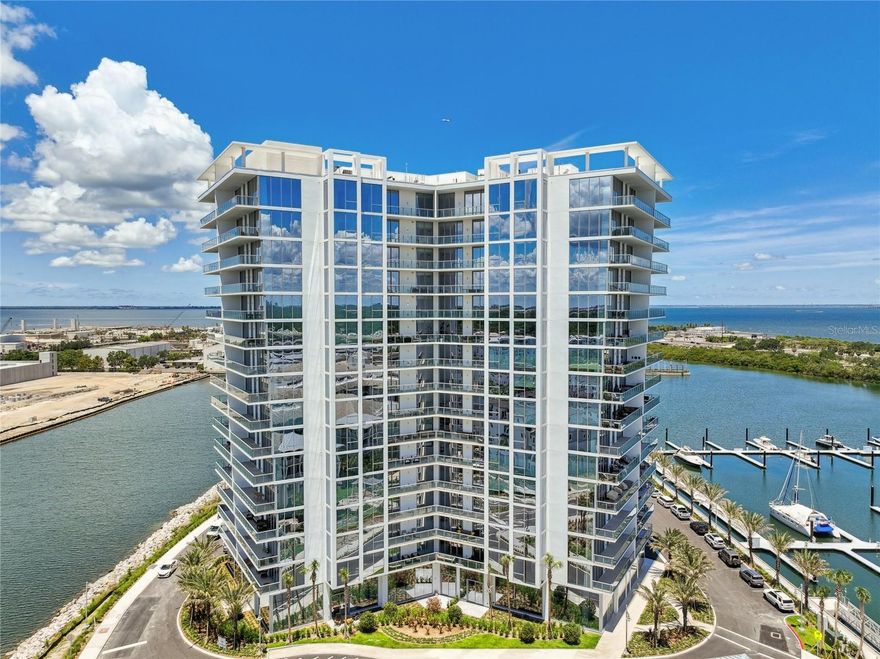 Indulge in the tranquil haven that awaits you at the impeccably crafted 16th-floor Earhart unit at Marina Pointe. This breathtaking condo offers four bedrooms and three and a half bathrooms, all complemented by awe-inspiring views of Tampa Bay, Downtown St. Petersburg, Bayshore, and South Tampa skylines that will leave you spellbound. As you step into this expansive dwelling, be prepared to be embraced by an abundance of natural light and contemporary elegance that transcends all expectations. Unparalleled in its sophistication, this condo boasts exquisite high-end finishes from the elegant light fixtures, custom closets, waterfall-edge quartz countertop, and soft-close drawers to the captivating European-style birch color cabinetry and top-of-the-line Wolf and Sub-Zero appliances. Unleash your culinary prowess on the induction stovetop or unwind and entertain in style on the two magnificent terraces totaling 524 square feet. Floor-to-ceiling glass windows with mechanical window treatments add a layer of form and function to this sleek, fashionable space. This unit also provides the convenience of two dedicated parking spaces and one of the few spaces with a dedicated EV charger. All of which is complemented by a secure storage locker. Whether you seek a serene vacation retreat or a tranquil year-round abode, this condo will surpass all your desires. Located in the esteemed Westshore Marina District, you will have access to exceptional retail and culinary experiences, with Downtown Tampa, Tampa International Airport, and Downtown St. Petersburg all within close proximity. Marina Pointe East offers an array of luxurious community amenities to enhance your lifestyle—Marvel at the breathtaking vistas of Old Tampa Bay from your private residence or the fifth-floor amenity deck. Bask in the year-round heated resort-style pool and spa, or savor outdoor barbecue at the grilling stations. Pet owners will appreciate the secure off-leash dog park, while health enthusiasts can enjoy the state-of-the-art fitness center, outdoor yoga area with a serene zen garden, and private massage studio. It’s important to note that the seller is offering a 50-foot boat slip at the Marina to be purchased separately should a buyer so desire. Don’t miss the opportunity to experience this remarkable gem by the waterfront firsthand! Visit today and witness the epitome of contemporary coastal luxury.
