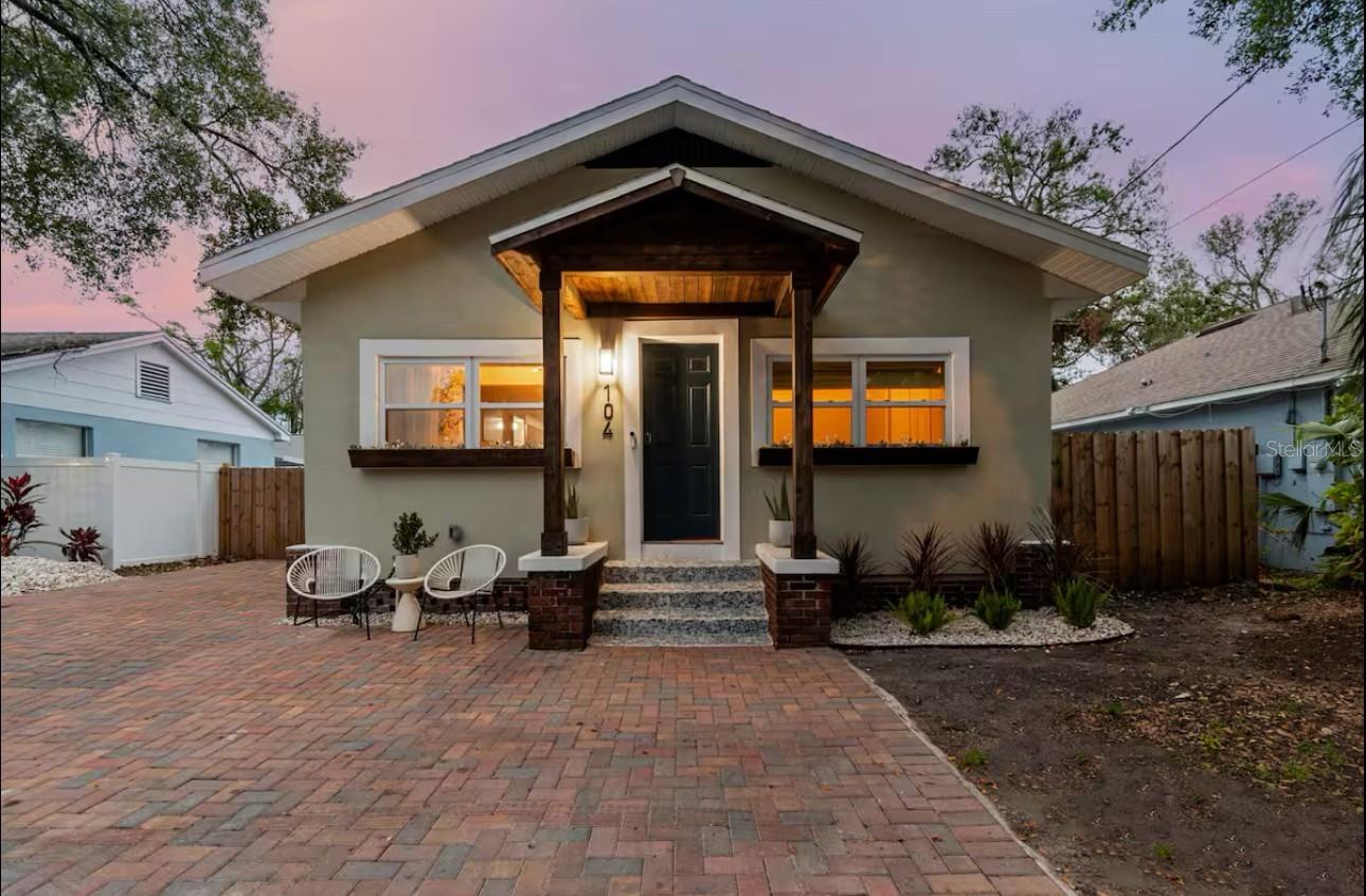 Discover the irresistible charm of 104 W Cayuga St, Tampa, FL 33603! This fully renovated 1925 Seminole Heights bungalow was designed to captivate from the inside out. Featuring 4 thoughtfully appointed bedrooms and 2 full baths, the home also includes a permitted 1 bed / 1 bath detached guest suite—unfinished but full of potential for rental income or extended family use. Step inside to find light-filled open spaces where modern comfort meets timeless character. Details include white oak laminate flooring, a marble-wrapped electric fireplace, ceiling fans throughout, white cabinetry topped with designer stone counters. The chef’s kitchen is a true showstopper—complete with Frigidaire stainless steel appliances, ample storage, and granite countertops with a bold waterfall edge. No expense was spared on updates:
Hurricane-impact windows, Newer roof, Full electrical rewire and panel, Updated plumbing and sewer lines, Tankless water heater, Newer HVAC system and ductwork. The luxurious primary suite offers a spacious retreat with an ensuite bath, dual sinks, and sleek porcelain tile finishes. Enjoy outdoor living with a fully fenced lot, new brick-paved driveway, and double gates—perfect for boat or RV parking. Entertain under the stars around the built-in firepit or relax in the peaceful ambiance of South Seminole Heights. Just minutes from Tampa’s top dining, shopping, parks, and major roadways, this home blends classic bungalow charm with modern-day livability. Don’t miss this house, it's stunning! Perfect for families, professionals, or investors seeking a standout property in a thriving neighborhood.