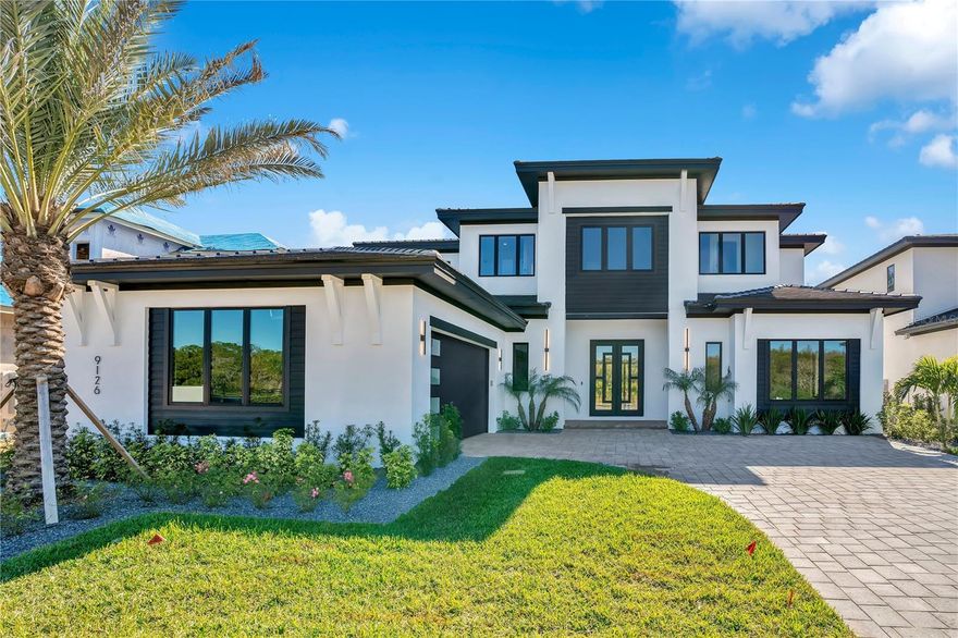 Built by Element Home Builders, the exclusive builder of Lake Sheen Sound, this newly completed custom luxury residence reflects exceptional craftsmanship, intentional design, and meticulous attention to detail. Ideally positioned between Dr. Phillips and Windermere, this home is set within Lake Sheen Sound—a private, boutique enclave of just 14 homes—nestled along the tranquil shores of Lake Sheen, part of the prestigious Butler Chain of Lakes. Offering 5,652 SF, the layout is designed for elevated everyday living and effortless entertaining, with direct sightlines from the entry to the covered lanai and resort-style outdoor setting.
The open-concept design is anchored by a chef’s kitchen with gas service, extra-thick quartz countertops, an expansive center island, an oversized walk-in pantry, and a pot filler. Fully integrated refrigerator and dishwasher with custom wood paneling deliver a seamless, high-end cabinetry finish. A formal dining room provides a dedicated space for hosting.
The main-level primary suite features a sitting area, an oversized tiled walk-in shower with dual shower heads, and two custom walk-in closets with built-in cabinetry. A first-floor guest suite with private bath adds flexibility. Additional bedrooms include walk-in closets with custom built-in systems.
Upstairs, you’ll find three en-suite bedrooms and a dedicated home theater/cinema room. Outdoors, enjoy a summer kitchen, dining area, and a convenient lanai-access powder bath. Heated pool currently under construction, expected completion in approximately three months, with paver deck.
Additional highlights include a two-car garage, EV charging capability, designer finishes, and high-end upgrades throughout.
Convenient to top-rated Orlando public and private schools, and just minutes from premier destinations including Walt Disney World®? and Four Seasons Resort Orlando, this home offers a rare balance of privacy, lakeside lifestyle, and everyday accessibility. Schedule your private tour to experience the sophistication, serenity, and exclusivity of Lake Sheen Sound.