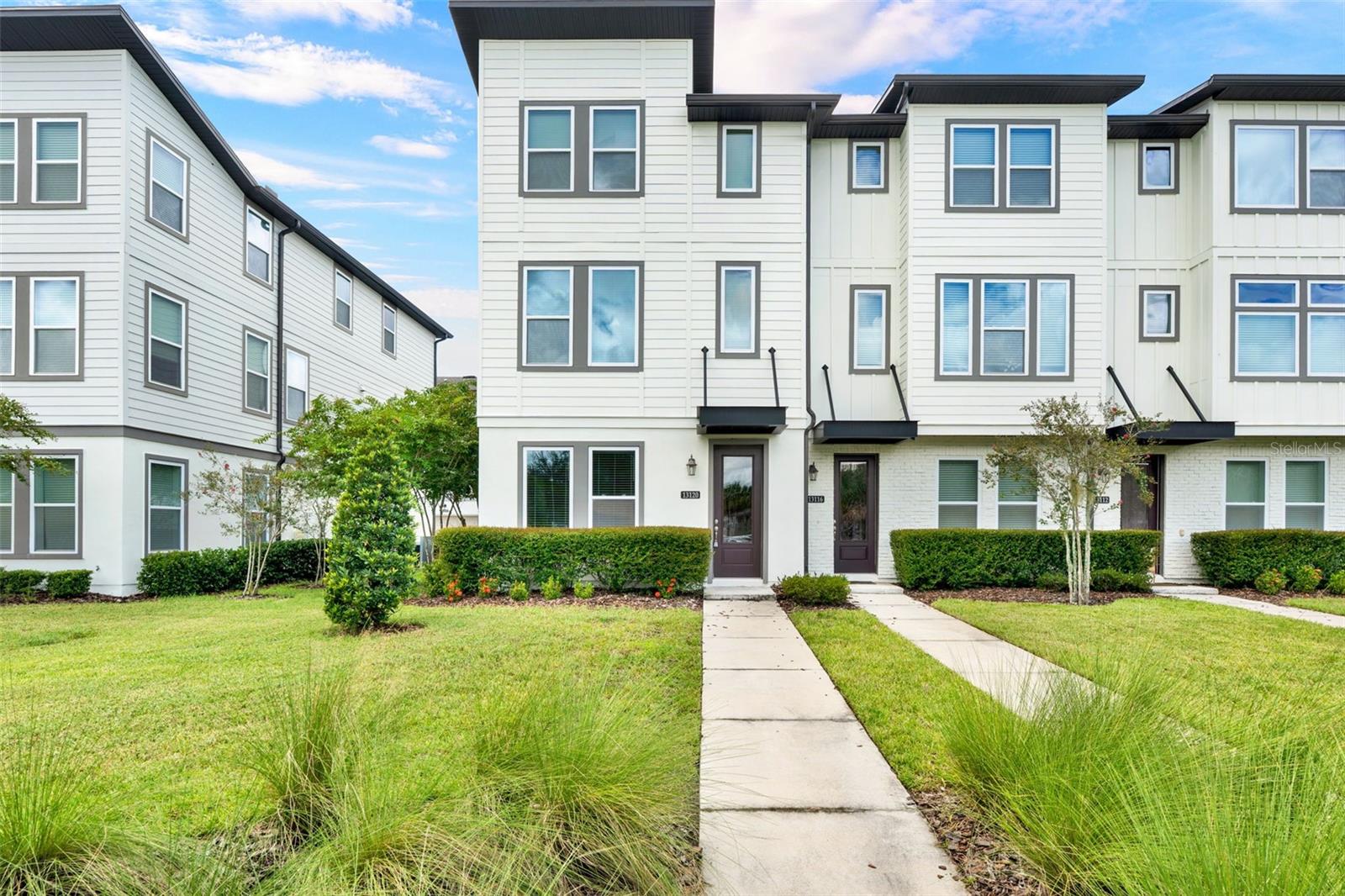 Move-In Ready END UNIT located in the prestigious Laureate Park at Lake Nona. Highly desired & LARGEST KILMER FLOORPLAN with OVER 2,200 SQFT, 25K+ in MODEL UPGRADES, PARK VIEW, FRESH PAINT, & NEW CARPET! This three story townhome features a bedroom, full bath, and garage on the first floor. Great room design on second story with living room overlooking the GOURMET KITCHEN and opening up to the dining room and PRIVATE BALCONY. Kitchen features 42' LEVEL 4 WHITE CABINETS and UPGRADED LEVEL 4 QUARTZ COUNTERTOPS including stainless steel appliances. VINYL PLANK FLOORING throughout living areas. Third level features master suite, master bath, as well as secondary bedroom and bath. All bathrooms highlight stunning LEVEL 3 CABINETS and QUARTZ COUNTERTOPS. RENT INCLUDES: fiber-optic speed internet & LP Fit Gym membership. The community also features access to the resort-like state-of-the art Aquatic Center with two swimming pools (family pool & quiet pool) and sand volleyball court, Canvas Restaurant and Café, Lake House event venue, community gardens, dog parks, and trails perfect for walking, running and bicycling. Located within desired A-rated schools! Conveniently situated near major highways, 417, 528, turnpike, and Orlando International Airport. Close proximity to Medical City, including UCF Medical School, Sanford- Burnham Institute, Veterans Affairs Hospital, Nemours Hospital, MD Anderson Cancer Center, US Tennis Association national headquarters and Lake Nona Country Club. This home will not last long, schedule your appointment today!
