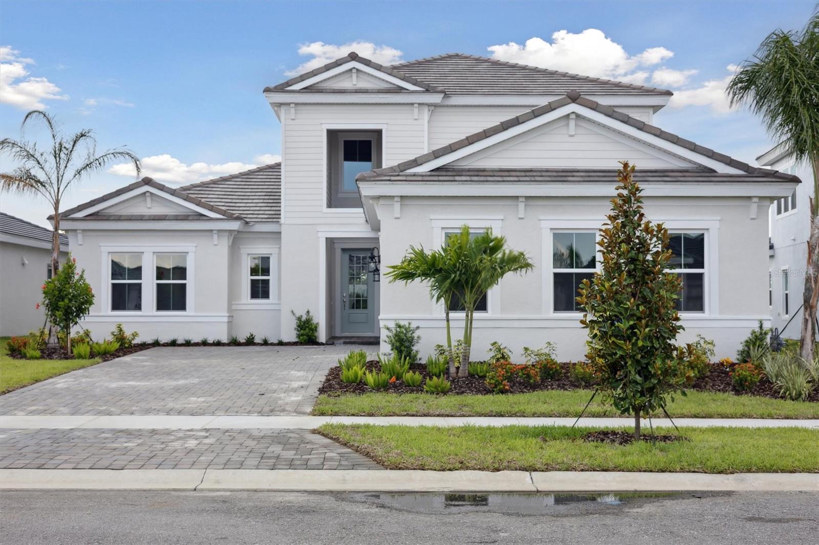 Sand Key II -
Discover your dream home with the Sand Key II, available now and designed for the Florida lifestyle. This stunning two-story residence boasts over 3,300 sq. ft. of meticulously crafted indoor living space, complemented by an additional 400+ sq. ft. of covered lanai, perfect for enjoying the sunshine year-round. Inside, you'll find elegant Sonoma Painted Linen cabinets, pristine Frost Whte MSI Quartz countertops, and luxurious Pride Plus LVP flooring throughout. With four spacious bedrooms, four bathrooms, a versatile formal den, and an oversized bonus room, every amenity for comfortable living is within reach. The owner's retreat features an upgraded stargaze relaxation master bath, offering a serene escape. Dramatic 14’ tall ceilings in the foyer create a grand entrance, while an oversized laundry room and a convenient 3-car garage complete this exceptional home. Further enhancing its appeal, this residence includes impact glass for comprehensive security, complemented by a serene private pool, offering an exclusive retreat for leisure and gracious entertaining.