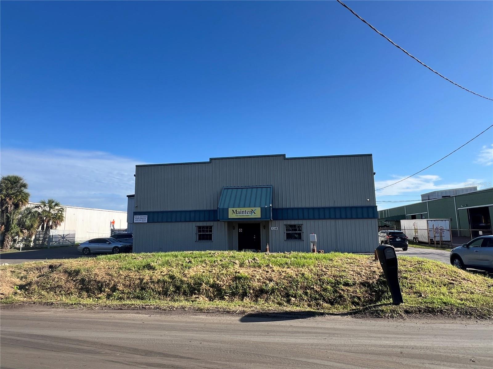 This Palm River / Claire-Mel Manufacturing (M) zoned industrial site is 2.14 acres and consists of two warehouse buildings totaling 51,599 SF inclusive of approximately 9,966 SF of working and partially enclosed canopy area. The main structure is a 40,069 SF warehouse with 19-21 ft clear height, multiple roll-up doors along the rear and sides of the main structure, and contains approximately 3,852 SF of air conditioned 2 story office space renovated in 2017. The rear structure, currently serving as a metal shop, is an 11,530 SF industrial warehouse with 14-16 Ft clear height. The incoming power service to the site is 3 phase (208v – 600 amp). There’s a transfer switch panel for generator power and 240-volt systems that include one 400-amp main breaker panel and two 200-amp panels. The site has access from both the East and West side of the main structure offering full turn access through the central concrete loading yard or can serve as additional lay down open storage area. The property has easy access to the Port and immediate service to Tampa, Brandon, South County, and Sarasota/Bradenton markets.
*Seller currently occupies property and will require 60 days to vacate, post closing.
Located just east of S. 50th Street / US 41 near the intersection of Causeway Blvd.