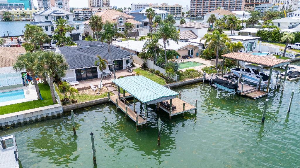 Stunning waterfront property steps from the beach with an open floor plan integrating the living, dining, kitchen, and oversized game room
areas making it perfect for entertaining and everyday living. Other features are the large laundry room with tons of storage, the high ceiling foyer that takes your breath away as soon as you step inside, the polished porcelain tile throughout, dual AC system, 2025 water heater.
In addition to the immaculate interior, the outside of this amazing home has a large circular driveway, several flower beds, herb garden, automated sprinkler system, covered boat dock with trex decking, and amazing views.
Bring your water toys to this deep water canal with the quickest access to the gulf and islands. Unbeatable location! All freshly updated including a new roof August 2025. Come take a look now and live the Clearwater Beach dream.
