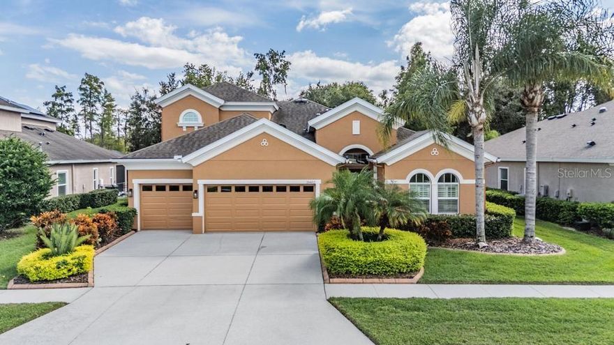 Nestled within the guard-gated community of Lakeshore Ranch, this breathtaking WestBay-built POOL and SPA home blends timeless elegance with modern luxury. Situated on a premium CONSERVATION LOT, this home offers five bedrooms plus a BONUS ROOM, four full bathrooms, and a three-car garage with a TESLA CHARGING STATION, all in a true four-way split floor plan designed for comfort, privacy, and functionality. From the moment you arrive, the lush landscaping and impressive curb appeal set the tone for what awaits inside. Step through the leaded glass entry door into a bright and open floor plan featuring 12-foot ceilings, 8-foot interior doors, crown molding, tile living areas and HARDWOOD FLOORING throughout all bedrooms. Designer light fixtures, custom ceiling fans, and refined finishes add sophistication at every turn. The gourmet kitchen is the heart of the home, showcasing 42-inch espresso wood cabinetry with crown molding and under-cabinet lighting, granite countertops, pendant lighting, a large center island, stainless steel appliances, and a natural gas cooktop with a stainless hood vent. The kitchen flows seamlessly into the grand room and casual dining area, highlighted by 12-foot sliding doors that open fully to the extended screened lanai, creating the perfect indoor and outdoor living experience. The outdoor space is a private retreat, featuring a HEATED SALTWATER POOL and SPA, panoramic pool cage, fully FENCED backyard and surround sound speakers, ideal for entertaining or unwinding with serene nature views. The owner’s retreat is a peaceful sanctuary with CUSTOM CLOSETS, dual vanities, a garden tub, and a frameless walk-in shower. The secondary bedrooms are generously sized and thoughtfully positioned in this four-way split design, offering space and privacy for every family member. The fifth bedroom, located upstairs with a full bath, can easily serve as a guest or in-law suite. Upstairs you’ll also find a spacious BONUS ROOM complete with a 100-inch movie screen and LG projector, making it the perfect home theater or entertainment area. The laundry room includes a utility sink, and additional cabinets for storage convenience. ADDITIONAL UPGRADES include:  2025 downstairs HVAC | 2022 Tankless Water Heater | 2025 Gas Pool Heater | 2024 Built-in Oven | 2022 Refrigerator | 2021 Dishwasher | 2021 Interior Paint | 2023 Exterior Paint | 2025 Bathroom Vanity Lights | Plantation Shutters | Landscape Curbing | Gutters with Gutter Guards | Surround Sound in the grand room, bonus room and lanai | Designer Lighting and Fans | Water softener, and MUCH MORE! Lakeshore Ranch offers resort-style living with a 24-hour staffed gatehouse, three community pools, clubhouse, fitness center, tennis and pickleball courts, dog park, fishing dock, basketball courts, and over 260 acres of conservation areas. HOA FEES INCLUDE basic cable, internet, and trash service. Conveniently located near top-rated schools, I-75, the Veteran’s Expressway, shopping, dining, and golf courses, this home truly embodies the best of Florida luxury living. Schedule your private showing today and make Lakeshore Ranch your next home.