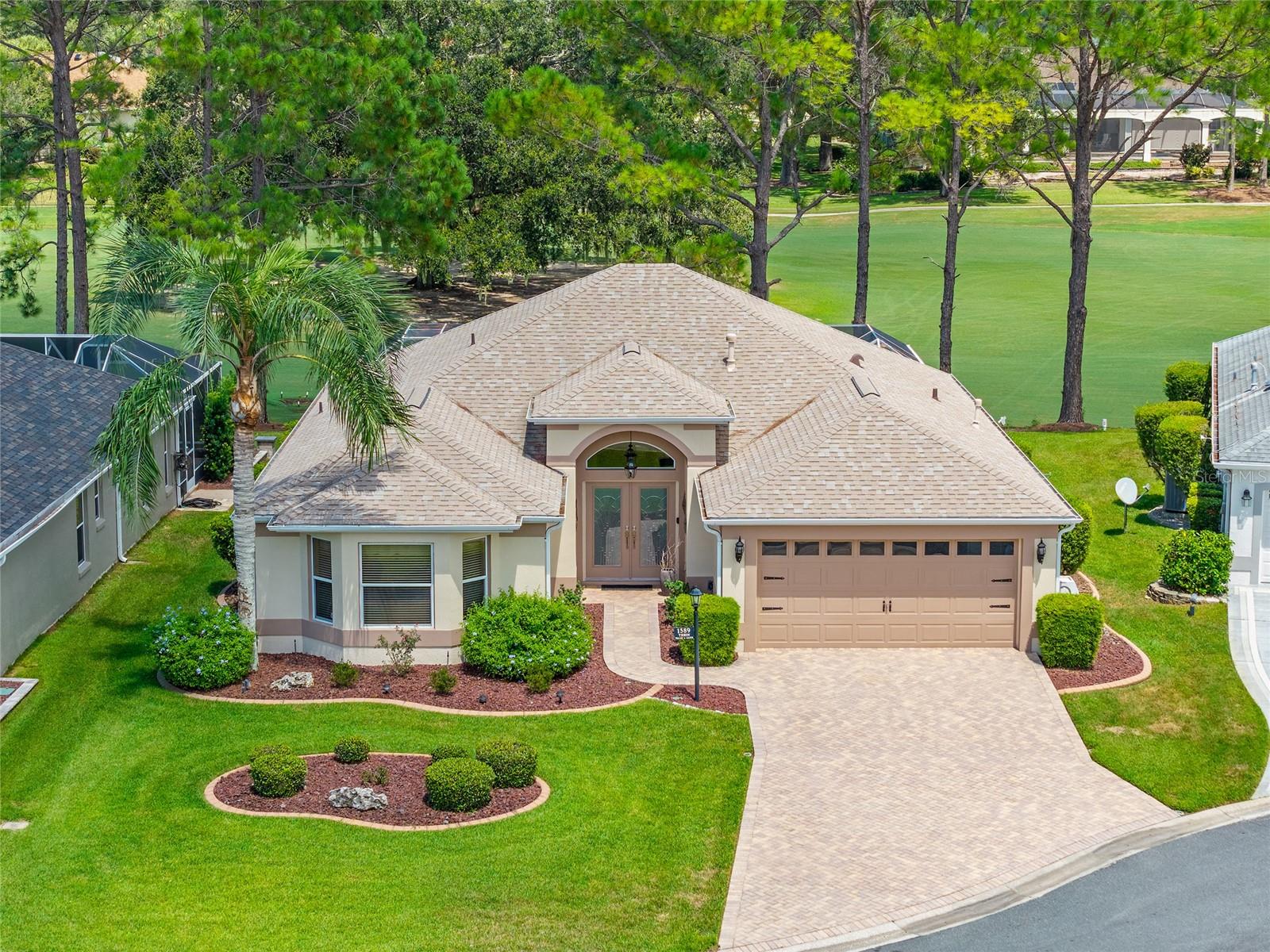 Luxury Living on the Glenview Championship Golf Course! Welcome to this exceptional Live Oak (Lantana) home, ideally situated in the highly sought-after Village of Belle Aire with NO BOND. Overlooking the premiere Glenview Championship Golf Course, this property offers STUNNING PANORAMIC VIEWS without the distraction of a golf cart path—ensuring peace and privacy. As you enter through ELEGANT DOUBLE DOORS, you're immediately greeted by expansive vistas and a bright, open layout that seamlessly blends indoor and outdoor living. The kitchen features beautiful GRANITE COUNTERTOPS, STAINLESS STEEL APPLIANCES, perfect for both everyday cooking and entertaining. A PAVER DRIVEWAY adds to the home's curb appeal, while the EXTENDED 46’ X 19’ BIRDCAGE/LANAI creates a true outdoor oasis. With STACKING SLIDING DOORS, CHATTAHOOCHEE RIVER ROCK FLOORING, and a TRANQUIL IN-GROUND FOUNTAIN, the lanai is designed for relaxation and enjoyment. Recent updates include a NEWER ROOF 2020, WATER SOFTNER 2021, and FRESH EXTERIOR PAINT 2022. The home also includes GARAGE ATTIC STAIRS for convenient storage access, along with GUTTERS AND DOWNSPOUTS for efficient water management. This exceptional Belle Aire home blends luxury, comfort, and an UNBEATABLE LOCATION—just minutes from Glenview Country Club, Glenview Tennis Club, the Savannah Center, and a host of other premier amenities that define life in The Villages. Discover the perfect setting to enjoy everything in this vibrant community. Schedule your private tour today and experience the elegance and tranquility of this remarkable home firsthand.