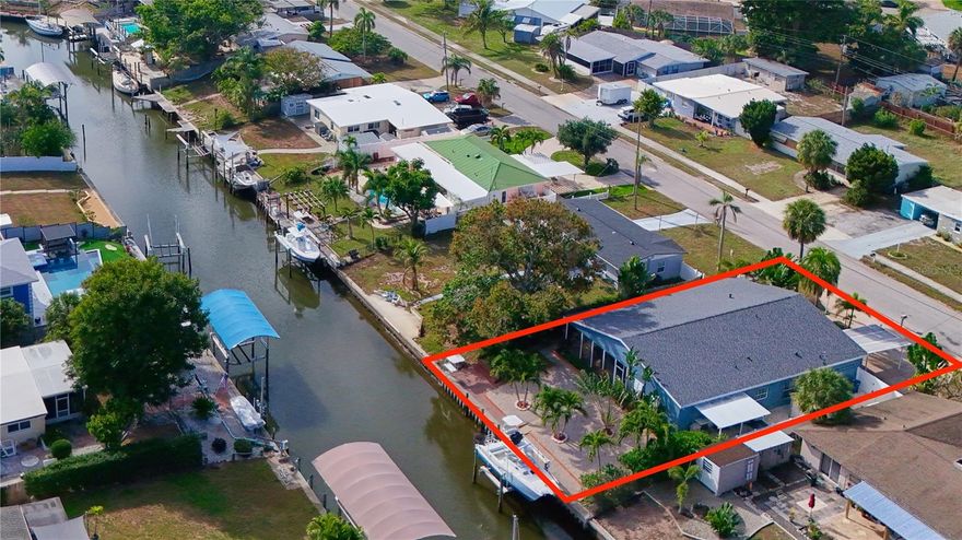 $43,000 PRICE IMPROVEMENT!! This tropical adventure home is the one you've been waiting for, where everyday living is a waterfront vacation!! This fully updated 2,400 sq ft, 4 bedroom/3 full bath home, is nestled on a deep, sailboat water canal with direct access to Sarasota Bay and the Gulf of America (no bridges) -  a boater’s paradise with wide, unobstructed access to sandbars, deep-water fishing, water sports, waterfront restaurants, beaches and more - all within minutes!! Enjoy 70 FEET of water frontage on this canal (with extra-wide width)!  In 2020, a NEW DOCK, NEW 16,000 lb. BOAT LIFT!! NEW SEAWALL (2015), and a fish cleaning station was completed!! You'll experience peace of mind here with a NEW ROOF!! NEW A/C (1 unit), 2-A/Cs. for zoned efficiency, impact-resistant windows, 2-Newer hot water heaters, newer appliances throughout! There is WHOLE-HOME GAS ENERGY for huge savings (also has full electric for flexible options). This home was never affected by Hurricanes nor storm surges! Entering the home, you'll be greeted with with an OPEN FLOOR PLAN, NEW TILE THROUGHOUT, NEW large, CUSTOM KITCHEN with REAL WOOD CABINETS and generous, STONE COUNTERTOPS and bar seating! The dining/flex space is currently enjoyed as a game room with a pool table perfectly situated for family and friends to have fun. There are TWO generously-sized PRIMARY bedrooms (en suites) with updated bathrooms offering many flexible options for guests or mother-in-law suite possibilities. There is a spacious, indoor laundry room. Don't miss all the hall closets that were smartly added during 2003 renovations.  Step into the heartbeat of this exceptional home - the EXPANSIVE, UNDER ROOF/SCREENED LANAI! This sanctuary offers year-round enjoyment of endless sunsets overlooking the canal and is embraced by the tropical retreat of the upgraded grounds and rich, tropical landscaping.  Whether your entertaining large gatherings with Al fresco dining or taking a rest after boating/fishing with family, this large space is set-up for it all with brand new tile flooring, large outdoor kitchen/bar, gas stove cooking (perfect for your fish), refrigerator, deep freezers (perfect for your fresh catch of grouper), and a commercial ice maker! There is ample space for a future pool. Bring your RV - there is dedicated parking on the side of home with vinyl gate/fencing. You'll appreciate additional parking spaces which includes a carport, extended and circular driveway. The yards have well-irrigation throughout (more savings). There are NO HOA/NO DEED RESTRICTIONS - (NO FEES), but residents of Bayshore Gardens enjoy an amenity-rich community with an Olympic-sized pool (only $10/year key fob access), pickleball, tennis, basketball courts, playgrounds, a wood shop, private marina, and boat launch.  This home is located in a coveted location with convenient access to award-winning beaches, Anna Maria Island, Siesta Key, SRQ Airport, IMG Academy, Downtown Sarasota dining and shopping. Homes like this at this price point, with direct Gulf access and waterfront/canal living, do not last long, so schedule your private showing today and let your ultimate, Florida waterfront lifestyle begin! Be it a full-time home, vacation retreat, or an income-producing rental (short term rental IS allowed), you'll quickly see the unrivaled value this home has to provides for waterfront living in Bradenton/Sarasota! Pool table, 2 deep freezers, commercial ice maker, remain! Furnishings are negotiable!