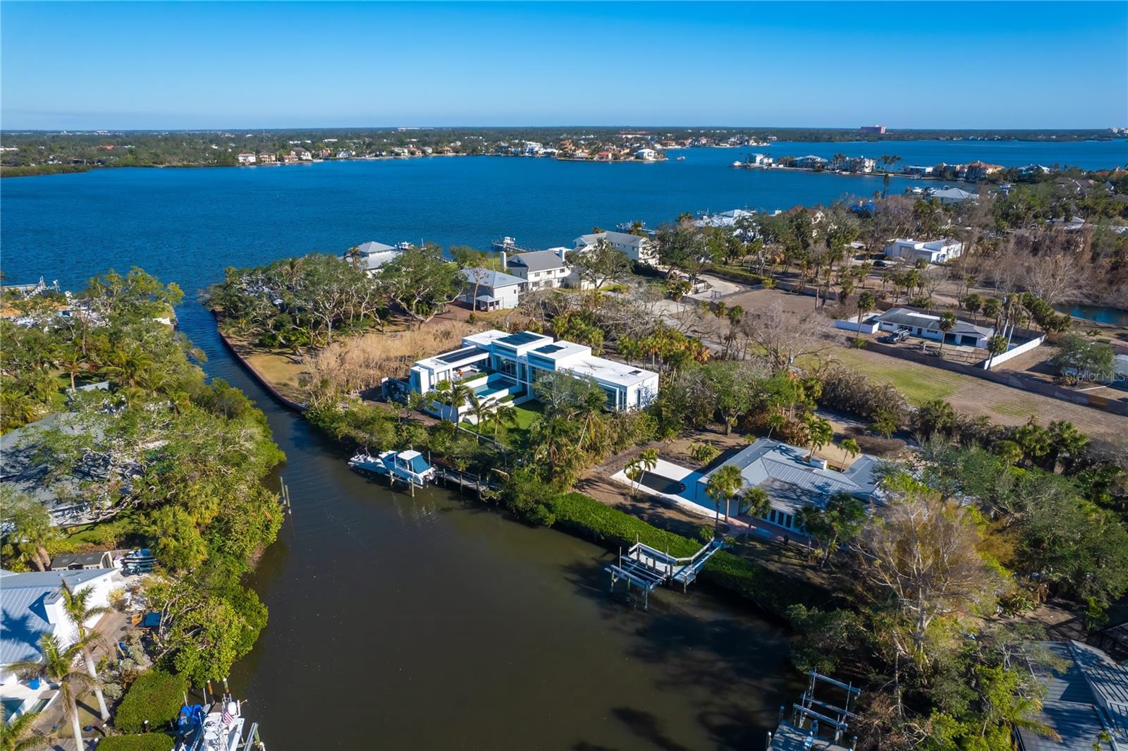 A rare waterfront opportunity. Ideally just three lots from Sarasota Bay on sailboat water, with no bridges to the bay, this property presents an opportunity to be a member of the Sanderling Club and live on boating water. Renovate or elevate the structure or raze and build your dream luxury home in one of Florida’s desired coastal communities. For boating enthusiasts, the property provides direct sailboat access to Sarasota Bay, the Intracoastal Waterway and Gulf of Mexico via the recently reopened Midnight Pass. Please note the existing structure on the property was storm-damaged, has been remediated and is ready for the next owner's vision. The property is being sold for land value, offering a unique opportunity to create your custom waterfront estate on the private, nearly one-half-acre property. Outside the gates, yet part of the Sanderling Club, residents enjoy a serene lifestyle with access to social events and a private community beach where, each evening, the Gulf of Mexico paints the sky with breathtaking sunsets, creating a picture-perfect backdrop for relaxation. This property is more than just a piece of land, it’s an invitation to embrace the beauty, luxury and convenience of coastal living. Conveniently close to Siesta Key’s world-renowned crystal quartz sands, Turtle Beach, and the vibrant dining and shopping scene of Siesta Village and the South Village. Just a short drive away, downtown Sarasota offers a wealth of cultural attractions, including theaters, ballet, opera, museums and art galleries.