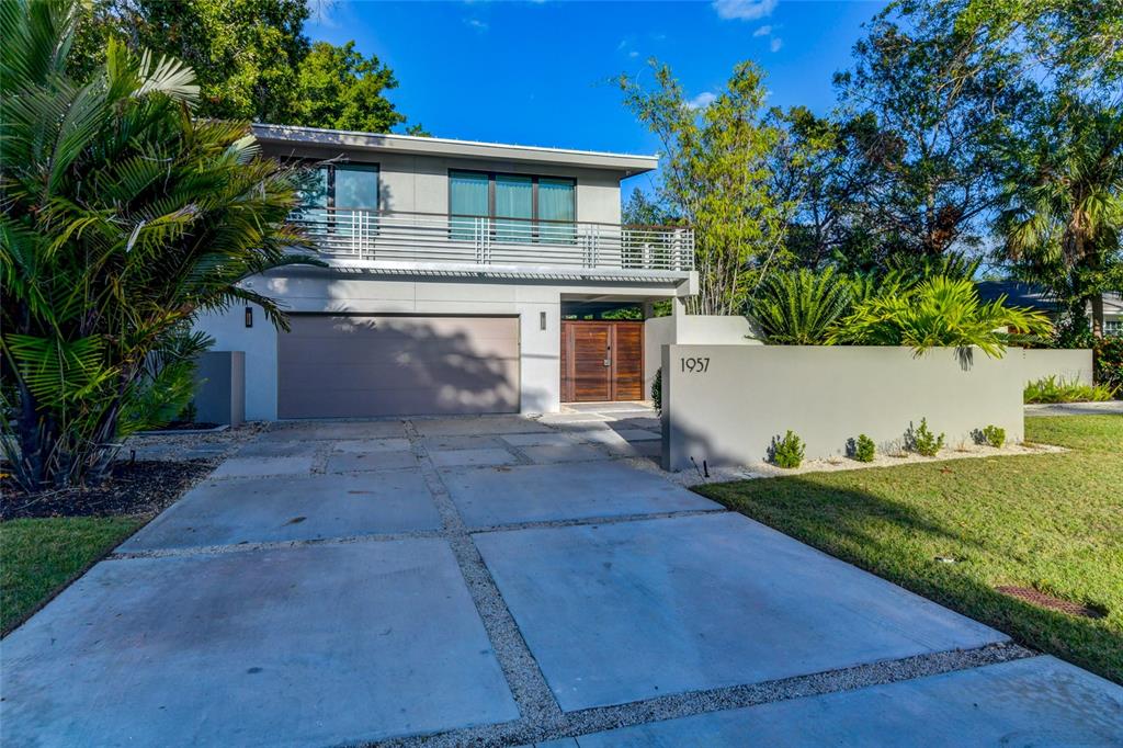 Welcome home to this gorgeous and completely renovated, FULLY FURNISHED mid-century modern luxury gulf access/pool home with two boat lifts, located on Hudson Bayou and featuring luxury finishes. Located WEST OF TRAIL in the sought-after Southside School district, this 3 bedroom, 3 bath open concept residence was completely reimagined and redesigned with elegance. Enter through the custom Jamie Beckwith front door into the absolute stunner of a great room with a beautiful water view, vaulted ceilings, transom windows, wide plank wood floor, and an abundance of natural light that floods the space through large impact glass sliding doors which flow seamlessly to the outdoors. The kitchen is a Chef's dream, anchored by the large marble topped island that seats 4. Prepare a fabulous meal with state-of-the-art stainless appliances including Wolf 5 burner induction cooktop, Samsung refrigerator, Bosch wall oven and microwave/convection oven, soft-close wood cabinetry, convenient pantry, and under cabinet lighting. The adjacent dining room boasts its own lovely water view and is anchored by an authentic Louis Poulsen chandelier. A 1st floor guest suite with full bath will be a treat for any guest with private courtyard access, marble floor, and ensuite bath redesigned with luxe vanity, glass/stainless shower, and marble floors and walls. The hardwood staircase leads to a warm and inviting upstairs space and stunning owner's suite, combined with an outdoor terrace, beautiful pool view, custom walk-in closet, designer window treatments and privacy blinds. The spa-like bath is set amongst the treetops with beautiful custom windows that allow just the right amount of light to enter the space. Designed with dual sinks, glass walk-thru shower, focal point Ironies light over the gorgeous soaking tub, and porcelain tile floor. A 2nd guest bedroom/office is generously sized with custom wood built-in desk/cabinetry, vaulted ceiling, and wide plank engineered hardwood floors. A full bath with glass/tile shower, Corian counters, LaCava Zebra wood vanity, and Setai Porcelain tile floors round out the 2nd floor. The outdoor space at this residence is breathtaking with privacy walls, stately wood/iron gates, lush mature landscaping, and stunning, private courtyard. Enjoy gorgeous water views from multiple outdoor spaces or lounge by the 38 foot heated, pebble tech Esther Williams pool with beautiful waterfall feature surrounded by the natural coral stone deck. Observe an abundance of wildlife in their natural habitat, or take the boat out for the day right from your backyard and 10,000 # boat lift. A convenient 1st floor laundry room with ample storage and utility sink and 2 car garage with polyaspartic floor and storage space. Other upgrades include metal roof, Level 5 drywall finish, HomerWood Aesthetics engineered hardwood floors, recessed LED lighting, custom window treatments, 11 camera security system, 2 ACs, whole home dehumidifier, all plumbing and wiring redone. The sought-after West of Trail neighborhood is a short walk or bike ride to Southside Village restaurants, shops and cafes, and close to #1 Siesta Key Beach and Bayfront, Sarasota Memorial Hospital, Selby Gardens, and Downtown culture and restaurants. Experience the delightful breezes in a setting that embodies the true feeling of the spectacular Gulf Coast!