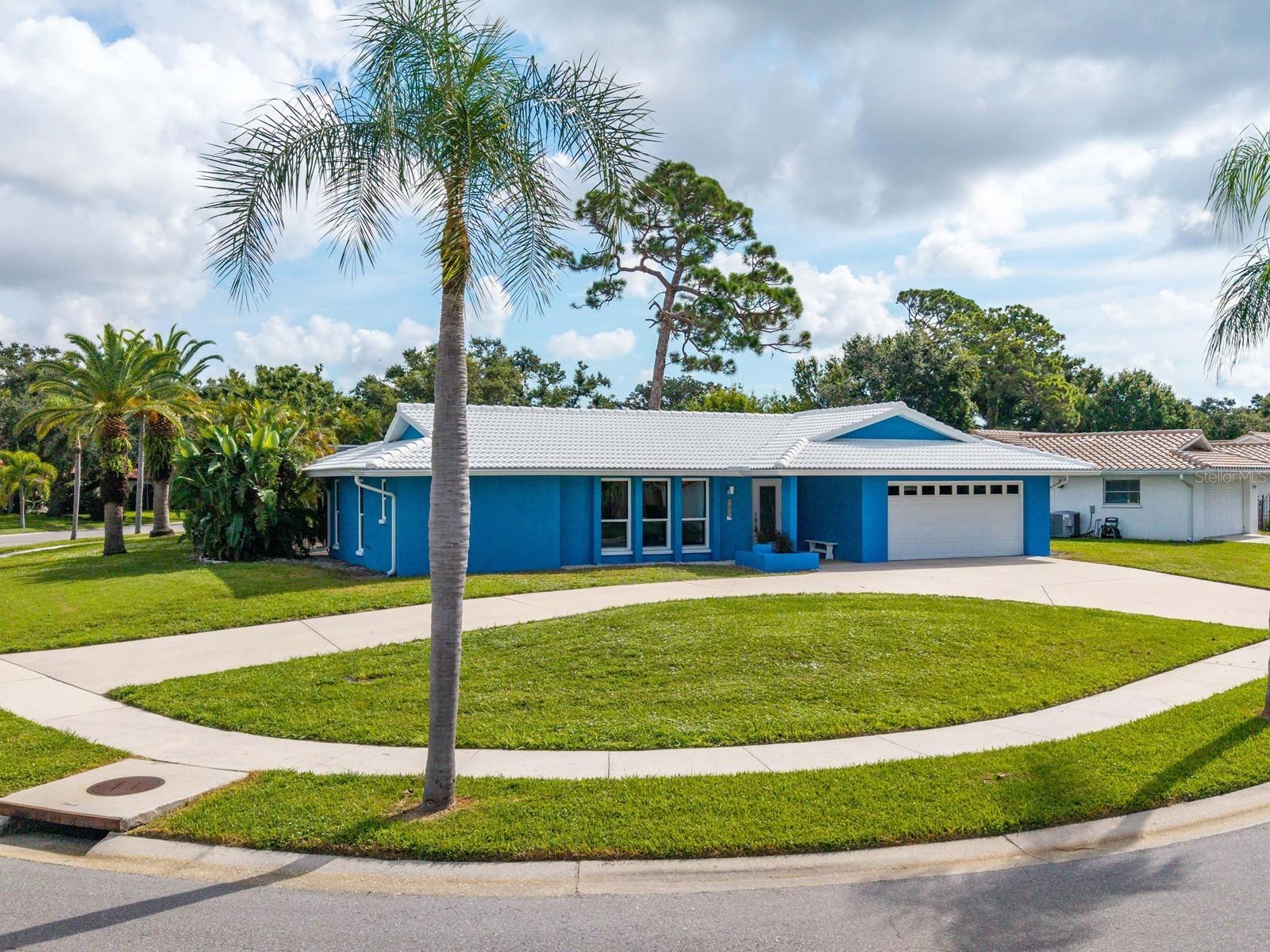 Four-Bedroom Pool Home on a Large Corner Lot! This beautifully refreshed home has been meticulously cleaned, with every inch of the interior repainted from ceiling to floor, creating a bright and inviting atmosphere throughout. The exterior features new, durable, impact-resistant windows and doors, a freshly pressure-washed surface, a beautifully refinished pool deck, and a newer tile roof that enhances its appeal! Your guests are warmly welcomed by a charming covered front porch that leads into the living room, featuring a front door with elegant glass inlay. The living room showcases lovely ceramic tile floors that extend throughout much of the home. Adjacent to this space, the formal dining room offers a view of the sparkling pool through sliding glass doors. A pocket door provides privacy from the kitchen, which showcases Corian surfaces, stylish cabinetry with task lighting, a built-in pantry, and glass display shelving. You will appreciate the convenient pass-through to the covered entertainment area on the lanai. The premium stainless-steel appliances remain. Recessed lighting improves the seamless transition from the kitchen to the family room, showcasing the pool view through another set of sliding glass doors. A pool bath is located next to three full bedrooms, one of which features parquet wood flooring. The laundry room, which also has access to the exterior and garage, is situated nearby. The split-plan layout ensures privacy in the primary suite, featuring its own en suite bath; a well-designed three-piece washroom, complete with all the essentials for both comfort and convenience. The spacious room includes a walk-in closet and direct entrée to the screened lanai, which features a covered area and swimming pool. Enjoy outdoor entertaining with tropical privacy on an oversized corner lot bordered by sidewalks. This home is in the Gulf Gate Woods community, which features deed restrictions and a voluntary association. It is less than a mile from Sarasota Bay and boasts a fantastic central Sarasota address, just 10 minutes from Siesta Key beach. The neighborhood is situated in a desirable school district, with Gulf Gate Elementary School about 2 miles away and zoning for Riverview High. Additionally, it offers a convenient drive to Pine View, which is just about 10 minutes away. You'll find various shopping options conveniently located nearby, including Costco, Total Wine, Sprouts, Publix, Target, and Starbucks. The property is also close to the Gulf Gate Public Library, shops, and dining at Sarasota Pavilion. You'll enjoy easy access to local attractions, including beautiful white sugar sand beaches, championship golf courses, Potter Park, and the Selby Aquatic Center, along with many other recreational venues such as the YMCA and Legacy Trails.