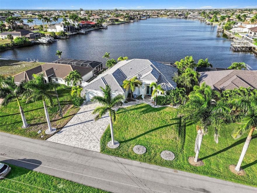 Welcome to 4227 NW 28th Street, a remarkable direct Gulf-access waterfront residence that seamlessly blends tranquil coastal living, strong investment potential, and everyday luxury. Currently operating as a rental property, this home presents an outstanding opportunity for investors, second-home buyers, or full-time residents seeking both lifestyle and income flexibility in one of Cape Coral’s most desirable boating locations.

From the moment you step through the front door, you are immediately drawn to the breathtaking water view. The home is perfectly positioned overlooking a serene lake that opens directly to the Gulf with no bridges, creating a stunning focal point that sets the tone for the entire experience. Natural light fills the space, enhancing the home’s soft aqua coastal palette that flows effortlessly from room to room, creating a calm, peaceful, and welcoming atmosphere throughout.

Built in 2018, this thoughtfully designed 3-bedroom plus den, 3-bath residence offers 2,526 square feet of living space with a split-bedroom floor plan ideal for privacy, guests, and extended stays. Architectural details such as tray and coffered ceilings, French doors, built-in cabinetry, a wet bar, and expansive tile flooring elevate the home’s refined yet relaxed coastal style.

The kitchen is designed for both entertaining and everyday living, featuring a large island, double ovens, wine cooler, reverse osmosis system, ample cabinetry, and seamless flow into the main living and dining areas—all positioned to keep the water view front and center.

The outdoor living space is truly where this home shines. Step out onto the expansive screened lanai and experience a peaceful retreat designed for relaxation and entertaining alike. The heated saltwater pool and integrated spa are enhanced by a reverse osmosis system, providing exceptionally clean, high-quality water—an uncommon and highly desirable feature. The outdoor kitchen, generous covered seating areas, and tranquil water backdrop create a resort-style setting that guests and owners alike will appreciate.

The primary suite offers private lanai access, calming water views, and a spa-inspired bath complete with dual sinks, a soaking tub, and multiple shower heads. Additional guest bedrooms and a flexible den provide versatility for rental use, home office space, or extended family visits.

No HOA, this property includes a 3-car garage, paver driveway, impact-resistant windows and doors, and strong curb appeal. With direct Gulf access, no bridges, and a peaceful lake setting, this home offers a rare combination of privacy, boating convenience, and strong market demand.

Whether you choose to continue its use as a rental, enjoy it as a seasonal retreat, or make it your full-time waterfront sanctuary, this property delivers tranquility, functionality, and long-term value—all in one exceptional Cape Coral address.