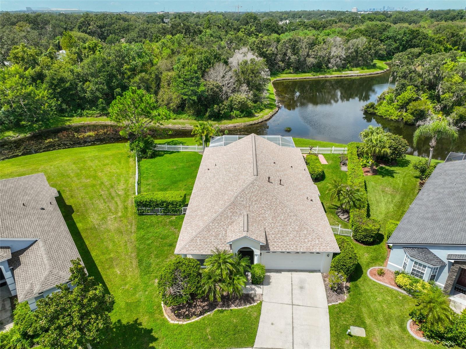 One or more photo(s) has been virtually staged. Welcome to your dream POOL & JACUZZI home in the gated community of Woodberry, complete with a BRAND-NEW ROOF installed in 2023. Overlooking a wooded conservation area with tranquil pond and no rear neighbors, this 4-bedroom, 2-bathroom home offers both privacy and convenience. Inside, soaring ceilings, fresh interior paint, and abundant natural light create a bright and inviting atmosphere. The spacious kitchen is a chef’s delight with white cabinetry, double ovens, a gas cooktop, walk-in pantry, and center island—all opening to the family room and screened lanai. The primary suite offers new carpet, a large walk-in closet, direct pool access, and a private en-suite bath with dual vanities, soaking tub, and separate shower. Step outside to your own backyard oasis featuring a sparkling pool and spa overlooking peaceful water views—ideal for both relaxing evenings and entertaining. Located just minutes from the Lee Roy Selmon Expressway and all of Brandon’s premier shopping, dining, and conveniences, this home combines modern updates, desirable outdoor living, and an unbeatable location. Don’t miss the chance to call this move-in ready pool home yours!