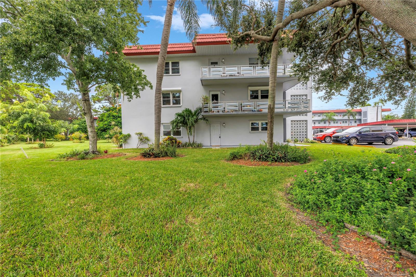RARELY AVAILABLE – GROUND FLOOR, CORNER UNIT with a great view and a nearby carport! This highly desired corner unit is overlooking a park-like setting, including a private pavered patio, trees and benches. The open floor plan is light and bright and easy to entertain in. Updated kitchen features hardwood soft-close cabinets, granite countertops, and a dedicated pantry. There is BOTH a breakfast bar for casual dining and a dining room. Enjoy your morning coffee on the private patio while enjoying the garden. Primary bedroom is spacious and can accommodate large furniture and has a large walk-in closet. Primary includes a private en-suite bathroom complete with a tiled walk-in shower and granite vanity. Guest bedroom is also spacious and also includes a large walk-in closet. Updated guest bathroom features a tiled walk-in shower and granite vanity. No detail has been missed. Updates include: Newer impact rated windows (2018), and AC (2015). This gorgeous unit was freshly painted and is move-in ready! A quick closing is OK here! Low monthly HOA fees include building insurance and exterior maintenance, gas for cooking and heating, water, sewer, trash, cable and Internet are all included – SAVES YOU MONEY $$!! Five Towns has tons of social opportunities, and has extensive amenities including six heated pools, a fitness center, card rooms, a billiard room, tennis courts, clubhouse/entertainment centers, bocce ball, horseshoes, and shuffleboard courts. Close to restaurants, shopping and award-winning beaches.