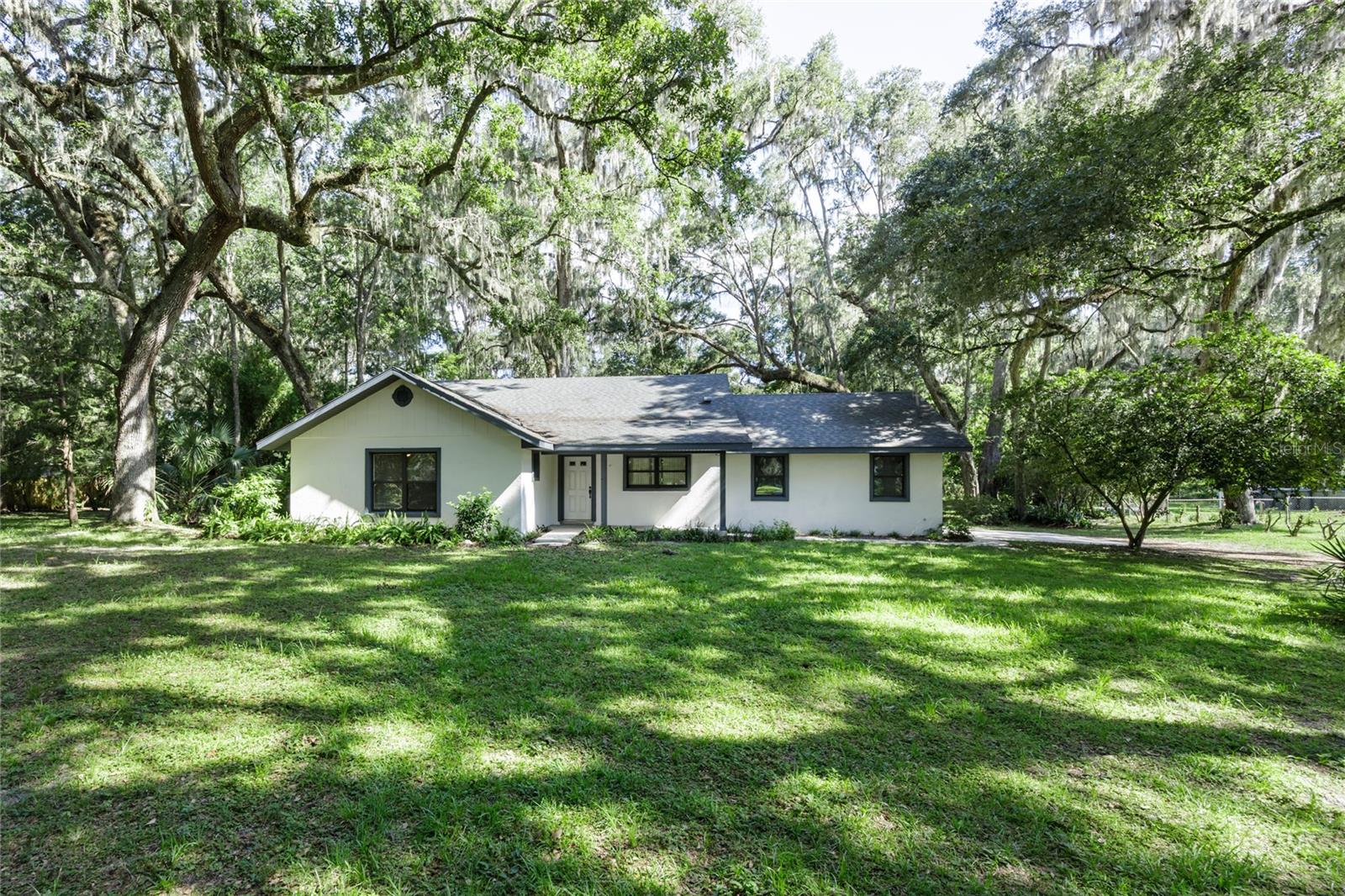 Don’t miss this charming 3-bedroom, 2-bathroom home nestled on a peaceful 1-acre wooded lot! Step inside to find a spacious open floor plan, perfect for entertaining guests or enjoying quiet evenings at home. Tile flooring throughout the main living areas makes cleanup a breeze, while cozy carpet adds comfort in the bedrooms. The master suite boasts a generous closet and a walk-in shower for your daily retreat. Calling all home chefs—the kitchen offers ample counter space for cooking and gathering. The split bedroom layout provides added privacy, ideal for families or hosting guests. A 2-car garage offers plenty of space for your vehicles, tools, or toys. Unwind on the screened-in back porch with your morning coffee as you take in the serene views of nature—listen to the birds sing and watch deer pass through your private backyard. With a full acre of land, you’ll have all the space you need to relax, garden, or explore. This one won’t last—call today for more information! HOME IS ON CLAY ELECTRIC. Roof is 2013 & AC is a 2022.