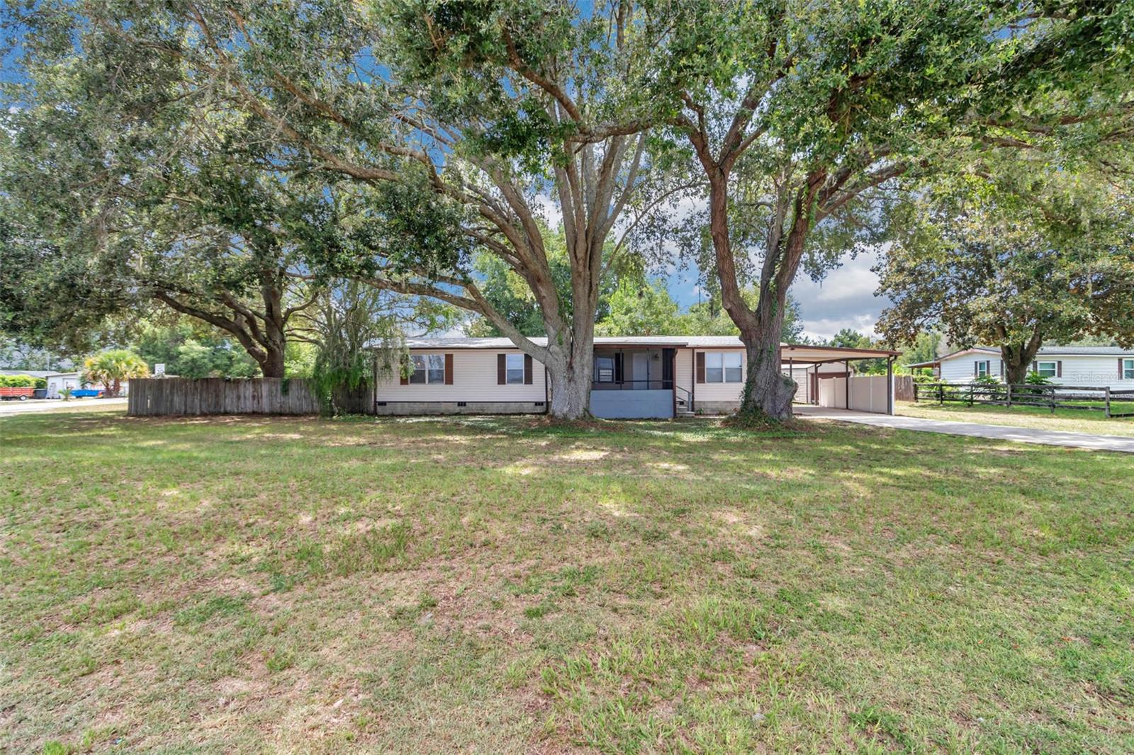 Discover your dream home in this beautifully updated 1,800+ square foot residence, nestled on a generous half-acre corner lot, just minutes from the scenic Florida Greenway. This inviting home boasts a large screened-in front porch, perfect for relaxing, and a climate-controlled rear lanai for year-round comfort. Inside, enjoy fresh updates including new flooring and paint throughout, a fully renovated guest bathroom, and a redesigned kitchen, laundry, and pantry optimized for functionality and style. The kitchen shines with all-new stainless steel appliances. Major systems have been upgraded for peace of mind, with the roof, air conditioning, and hot water heater all replaced within the last five years. Spacious guest bedrooms offer ample comfort, while the expansive primary suite impresses with a luxurious four-piece bathroom. Move-in ready and designed for modern living, this home combines space, style, and convenience in an ideal location. Don’t miss out—schedule your showing today!