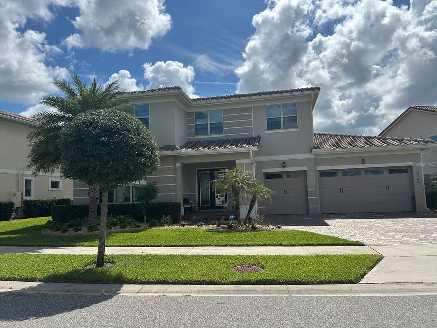 PROFRESSIONAL PHOTOS COMING SOON. Nestled within one of Central Florida's most exclusive neighborhoods this stunning home offers the perfect blend of luxury, comfort, and effortless entertaining. Located on a quiet cul-de-sac street boasting 5 bedrooms, 4.5 baths, a large loft and open floor plan this home is designed for everyday living and seamless hosting! Step outside to your private resort style salt water pool and enjoy nightly views of the Disney fireworks lighting up the sky! The upgraded "picture frame" pool screen design offers an uninterrupted view of the serene pond and the diverse wildlife that visits it! On the main level you will find the PRIMARY SUITE COMPLETE WITH A LUXURIOUS SPA LIKE BATH AND HUGE walk-in closet, a guest bedroom with its own full bath, the glass enclosed wine room and a convenient half bath for guests.  The GOURNET KITCHEN flows to the expansive great room where 4 large sliders can open to the covered patio for the "outside inside" living!! Upstairs, in addition to the large loft are 2 bedrooms that share a full bath and another private en-suite bedroom. Recent upgrades include beams on the main level ceiling, beautiful built-in wall unit in the loft, outdoor kitchen and outdoor lighting.  Located just minutes from Walt Disney World, premier shopping, dining, and everyday conveniences, and approximately 30 minutes to Orlando International Airport, this beautiful home is perfect for that unbeatable central Florida lifestyle!