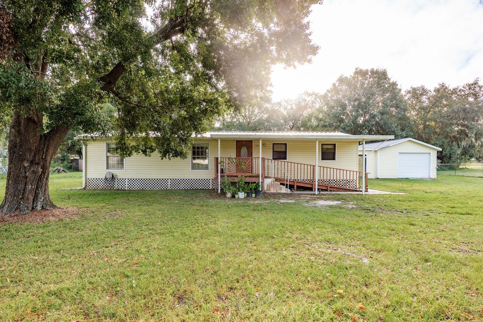 Welcome to this 3-bedroom, 2-bath double-wide manufactured home located in the desirable Angus Valley neighborhood of Wesley Chapel. Situated on over half an acre (.52 acres), this property offers a spacious 1,248 sq. ft. floor plan with a split-bedroom layout for added privacy. The open living and dining area flows into the kitchen, which features solid wood cabinets, stone counters, and a gas stove. Recent updates include a 2022 hot water heater, 2023 dishwasher, 2023 refrigerator, and 2023 oven. Enjoy a large detached garage and multiple storage sheds, perfect for all your tools and toys. Plenty of space to park your RV, boat, or trailer.” The home is equipped with central air, a heat pump, and propane washer/dryer hookups. Enjoy the peace of country-style living with no HOA fees while still being close to shopping, dining, major highways, and top-rated schools. With some finishing touches, this home has fantastic potential for its next owner.