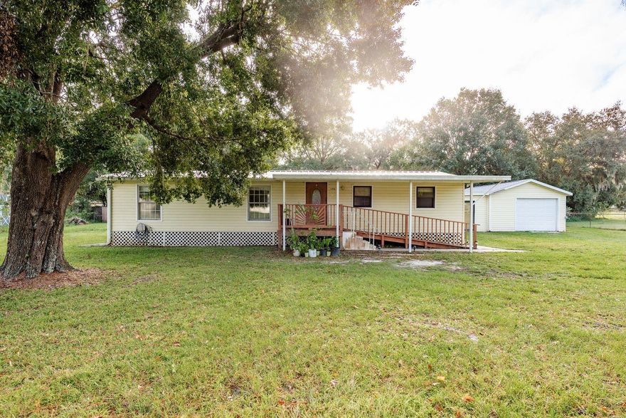 Welcome to this 3-bedroom, 2-bath double-wide manufactured home located in the desirable Angus Valley neighborhood of Wesley Chapel. Situated on over half an acre (.52 acres), this property offers a spacious 1,248 sq. ft. floor plan with a split-bedroom layout for added privacy. The open living and dining area flows into the kitchen, which features solid wood cabinets, stone counters, and a gas stove. Recent updates include a 2022 hot water heater, 2023 dishwasher, 2023 refrigerator, and 2023 oven. Enjoy a large detached garage and multiple storage sheds, perfect for all your tools and toys. Plenty of space to park your RV, boat, or trailer.” The home is equipped with central air, a heat pump, and propane washer/dryer hookups. Enjoy the peace of country-style living with no HOA fees while still being close to shopping, dining, major highways, and top-rated schools. With some finishing touches, this home has fantastic potential for its next owner.