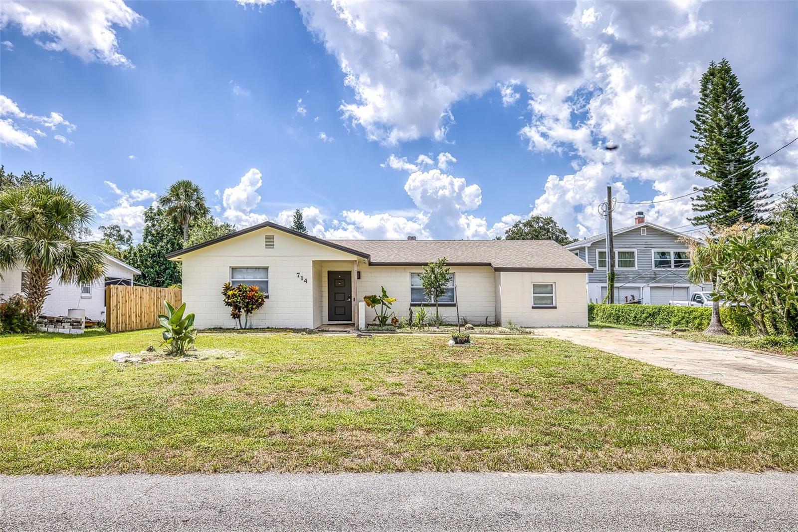 Updated & Move-In Ready in the Heart of New Smyrna Beach! Step inside this fully upgraded 2-bedroom, 2-bath home.  As you enter, you’re welcomed by tile flooring that flows through the entry, living, and dining areas, all enhanced with new lighting and stylish finishes. The kitchen is a true showstopper—featuring granite countertops, gray cabinetry, LTV flooring, and a charming mermaid tile backsplash that also wraps underneath the breakfast bar. A large stainless sink, GE Profile refrigerator, and stainless-steel appliances (except the dishwasher) complete this functional and beautiful space. Thoughtful touches like a Lazy Susan and updated electrical throughout the home add to its appeal. There is a spacious laundry room with LTV flooring, a utility sink, and hookups ready for your own washer and dryer. Both bathrooms offer granite vanities, cabinetry, higher toilets, and tiled finishes. The primary suite includes a generous walk-in closet and a huge walk-in shower, all accented by modern gray doors and trim throughout the home. Step outside to relax or entertain in the oversized, south-facing screened-in patio. The fully fenced backyard features white PVC fencing for privacy, along with two large sheds—one 10x24 workshop with power on the south side of the property, and a 12x24 storage shed on the west side. There’s also a concrete pad for a generator and an additional washer/dryer hookup in the workshop. Perfectly located just 1.7 miles to the North Causeway boat ramp, 3.3 miles to the beach, and around the corner from US-1, the Intracoastal, and the NSB Municipal & Hidden Lakes Golf Course, this one-story home offers comfort, style, and convenience—inside and out!