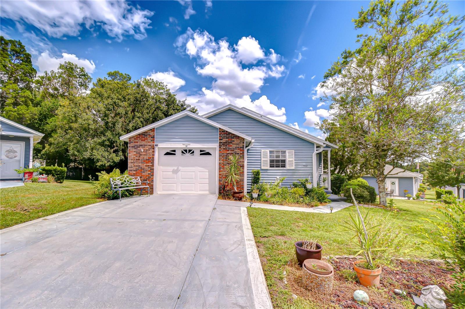 BEAUTIFUL WEDGEWOOD MANOR: This 55+ community boasts heated pool, clubhouse, shuffleboard and the low monthly fee covers basic cable, internet, grass cutting and use of the recreational facilities. Pet friendly with some restrictions and close to conveniences. Discover this 2-bedroom, 2-bath home that’s full of charm! The eat-in kitchen features a pantry, and built-in microwave and preparation bar, while the great room with a formal dining area offers plenty of space for entertaining. A cozy den provides the perfect spot for hobbies, TV viewing, or a home office. The large primary bedroom includes an oversized walk-in closet and an en-suite bath with a walk-in shower. Accented with engineered wood floors and tile. Such a comfortable home perfect for downsizing or winter nest. Active clubhouse with a monthly social calendar of activities to enjoy.