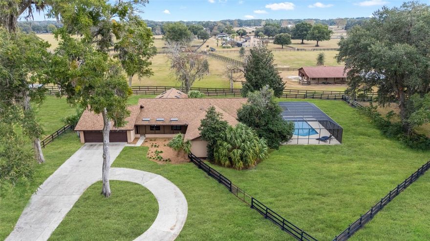 Welcome to your dream Hobby Farm, nestled in the serene and sought-after Meadow Lands, an exclusive equestrian community. This exquisite property offers a perfect blend of modern luxury and country charm. Step into this fully renovated 4-bedroom, 3.5-bathroom home, where every detail has been thoughtfully curated for comfort and elegance. The expansive floor plan features stunning wood floors and travertine tiles, exuding warmth and sophistication throughout.

At the heart of the home is a chef’s kitchen, a true masterpiece. With gleaming granite countertops, custom wood cabinetry, brand-new appliances, and a spacious walk-in pantry, this kitchen is designed for both functionality and style. Whether preparing a gourmet meal or hosting a casual gathering, there is ample space for family and friends to dine and enjoy.

The open-concept living and dining area invites you to relax and entertain with ease, boasting a large wood-burning fireplace that adds both charm and warmth to the space. Natural light floods the generous primary suite, creating a tranquil retreat. The luxurious ensuite bath is a sanctuary in itself, with exquisite granite countertops, travertine tiling, a deep soaking tub, a walk-in shower, and even a sauna—perfect for ultimate relaxation.  Each guest bedroom is generously sized, providing ample space for rest and storage. French doors off the kitchen open to an inviting lanai, ideal for alfresco dining or enjoying the natural beauty of your surroundings. The screened-in pool area offers an expansive and private oasis, perfect for unwinding or hosting summer gatherings. A spacious two-car garage provides ample room for vehicles, equipment, and extra storage.  This property also caters to the needs of your livestock with its fully fenced and cross-fenced land. The three paddocks are ready for your horses or other animals, while the charming 3-stall barn features both front and rear access for easy movement of animals. Additionally, the barn includes a large feedroom and tackroom for all your equestrian essentials.The Meadow Lands community is renowned for its wide easements and scenic trails, ideal for leisurely rides and connecting with fellow equestrian enthusiasts. This highly coveted area is just minutes from the vibrant city of Ocala and conveniently located off 441/301, providing easy access to Gainesville and beyond.

This property is more than just a home—it’s an extraordinary opportunity to own a turnkey hobby farm in one of Florida’s premier equestrian neighborhoods. Recent updates include a new roof, AC system, septic, pool screen, barn, appliances, and so much more.  Owner financing would be considered with the appropriate buyer qualifications. 

Don’t miss out on this rare gem. Embrace the lifestyle you’ve always dreamed of—your perfect hobby farm awaits.