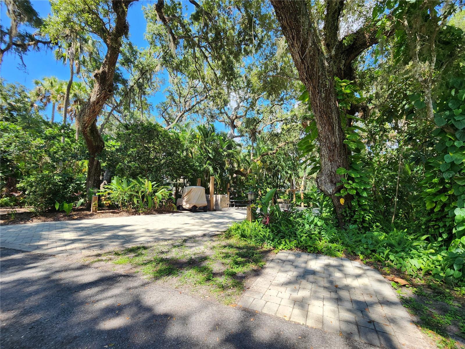 Welcome to amazing pavered Luxury RV Lot 316 Under a Canopy of Ancient Oak Trees. Surrounded by lush greenery, this property offers the perfect blend of comfort, convenience, and income potential. Located in Phase 3 – one of the most sought-after sections of the resort. Boasting a Brick Firepit built into the Lot pad with cozy Wooden swing & Picnic table for outdoor gatherings. This property features a separate golf cart parking space to the right hand side of the Lot entrance. Currently in the resort’s rental program with upcoming bookings. Let your lot earn income when you’re not using it! Just a couple streets away from Possum Path bathhouse with laundry, showers, and restrooms. Minutes from: Tennis & pickleball courts, Bocce ball & shuffleboard courts, 2 Resort pools/Hot Tubs. Adjacent to the Westgate River Ranch Resort, where you’ll find: Multiple on-site eateries, Even a Starbucks! Tons of fun activities including The River Country Waterpark (available at additional cost)
Golf Cart not Included with Sale
Disclaimer: All information deemed reliable but not guaranteed. Buyer to verify all information to their satisfaction.