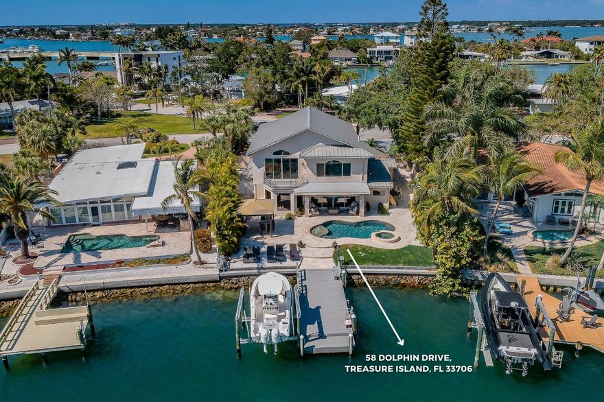 A masterful achievement of concept and design, this stunning custom built 3,629 square foot 2-story on grade WATERFRONT fenced residence showcases exquisite craftsmanship & cutting edge design. Onyx marble front entry! Seamlessly integrated indoor/outdoor spaces with a 2nd floor master balcony which affords gorgeous views of the Boca Ciega Bay, 70' of waterfront, private dock with 12,000 lb boat lift, dock & underwater lighting, saltwater pool with gas heated spa, led lighting, shell pathways, travertine marble pool deck & a sandy beach! Outdoor gazebo bar with granite tops, cabinets, perfect for entertaining guests. Illuminated by natural light the great room with its 19' cathedral ceilings, windows galore, bamboo hardwood flooring is open to the kitchen & dining. Culinary kitchen: stainless Viking appliances, quartz countertops, 48" Viking gas range, ice maker, dishwasher & microwave, subway backsplash. Butlers pantry with new cabinets & granite tops. The center island is perfect for afternoon snacks! Sumptuous 2nd-floor master suite overlooks the waterfront, French doors open onto a Juliette balcony overlooking the great room, glass door sliders open onto the balcony overlooking Boca Ciega Bay, his/her custom created walk-in closet, designer fans, vaulted ceiling. Sumptuous master bath, his & her marble top vanities, custom cabinetry, marble wainscoting jetted tub, plantation shutters, glass door marble walk-in shower with 2-shower heads. The 2 first floor secondary bedrooms have plantation shutters, fans, closets & wood floors. One bedroom has bathroom en-suite which serves as the perfect retreat for guests &/or family members. Guest bathroom marble top vanity, stacked stone, marble wainscoting, walk-in glass door shower. Professionally landscaped, sprinkler reclaimed water, 2-car garage, epoxy finished. Treasure island located along the Gulf of Mexico boasts white sandy beaches, pristine waters, unique restaurants and family friendly attractions.