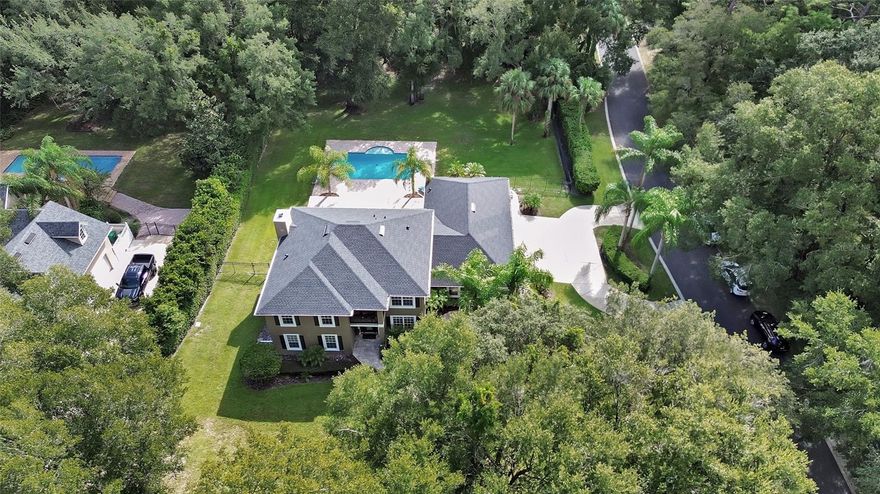 First Time on the Market  GREAT LOCATION!  Less than 5 minutes to I-4, offering FAST commute to Orlando, Daytona and New Smyrna Beach. One Owner Custom Arthur Rutenberg POOL Home, OVERSIZED 3 Bay attached GARAGE, on .91 ACRE with mature landscaping. Pride of ownership shines in this one-owner, custom-built 5BR/3BA home designed with quality and detail throughout. This two story beauty is constructed with cement BLOCK on both levels (no wood frame), offering long-lasting strength and style. Enjoy peace of mind with NEW in 2025, ROOF, HOT WATER HEATER, 2 HVAC systems, new toilets, updated electric inside & out, resurfaced pool with new pump.  Remodeled kitchen & baths (2023). Inside, you’ll find: Spacious first floor ACTIVITY/GAME Room with rich cherry wood floors, and a wall of closets for storage. Crown moulding & wood-look ceramic tile in main living areas. Great Room (Family Room) with wood-burning fireplace and cherry floors. Formal Dining Space and separate Dinette plus a beautiful Breakfast Bar Island lets you entertain with flexibility. 
Gourmet kitchen with stainless appliances, granite counters, cabinets with glass front tops, farmhouse sink, oversized breakfast island with storage, and large hall pantry.
Triple disappearing sliders open the home to a stunning 12x36 screened lanai with trussed roof, porcelain tile, and 220 hook-up for a hot tub. The lanai overlooks the 20x44 open paver patio and steps down to the 18x30 sparkling pool with full paver deck — perfect for entertaining or relaxing. There is a first floor pool bath with shower tub combo, dual sinks and granite counters, that also serves guests. PRIMARY SUITE offers vaulted ceilings, french doors to 8x5 deck/sitting porch to catch the last rays of the setting sun, an EN-SUITE bath with private garden tub and glass block window lighting, large walk-in shower, double sinks, granite counters, dual closets, private water closet. Hall bathroom strategically located on 2nd floor has dual sinks, granite counters and shower tub combo. All guest bedrooms are bamboo or LVP flooring, have closets with mirrored doors and are comfortably sized. Car enthusiasts will love the oversized garage which can hold 5 vehicles. Garage also offers 2 sets of pull down stairs for attic access/storage. This rare gem blends timeless craftsmanship with modern updates, making it the perfect place to call home. Don’t miss your chance to own this one-of-a-kind Arthur Rutenberg masterpiece!