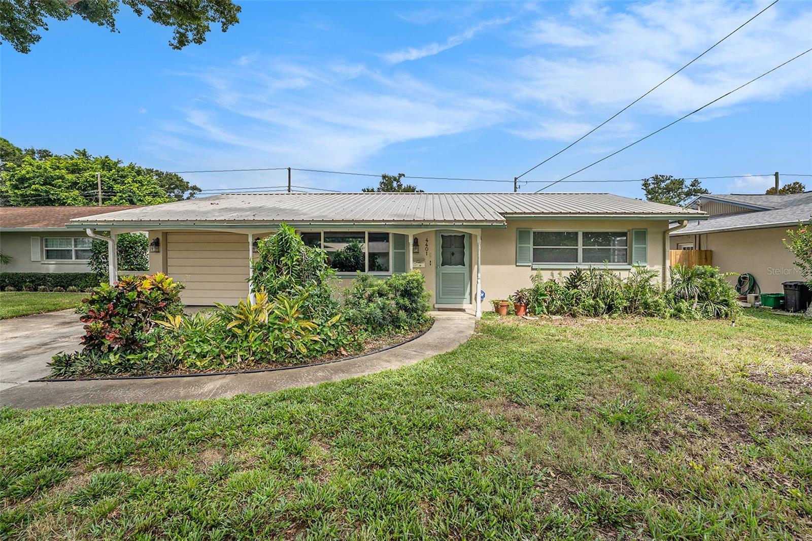 This Kenneth City gem won’t last! This beautifully updated 3-bedroom, 2-bathroom home is perfectly located just minutes from St. Petersburg’s award-winning Gulf beaches, vibrant downtown, dining, shopping, and entertainment — with no HOA restrictions. Inside, enjoy move-in ready living with luxury vinyl flooring, an updated kitchen, and a charming brick pass-through wall, connecting the kitchen to the living room, a unique touch you won’t find in every home. The primary bathroom skylight fills the space with natural Florida sunshine, creating a bright and airy retreat. Step outside to your private backyard oasis featuring a fully fenced in yard, lanai, paver patio, and lush mature landscaping ideal for entertaining or simply soaking up the Florida lifestyle. A durable (2017) metal roof, impact rated windows, and updated electric (2021) offer peace of mind and lasting value. If you’ve been searching for a St. Petersburg area home for sale with character, updates, and an unbeatable location, this is the one. Don’t wait — schedule your private showing today before it’s gone!