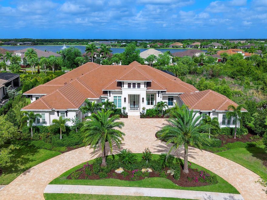 Located in the private enclave of Anchorage Place, an upscale gated street within the gated community of The Lake Club, is this one-of-a-kind and immaculate residence.  Custom built by Stock Custom Homes, this is one of only a few homes in the area to be built by the prestigious luxury division of Stock.  Every detail within this residence has been hand selected by Soco Interiors for an opulent and luxurious lifestyle.  This home graces an oversized lot of 0.65 acres and spans 4,892 SF with 4 bedrooms that all have private en-suite bathrooms, classic entertaining floor plan with spaces for formal and casual gatherings, a sumptuous primary suite escape, private study, laundry and mudroom, and 4-car split garages.  The lanai wraps around the entire rear of the home with multiple entertaining areas, custom outdoor kitchen, and custom pool and spa with garden views.