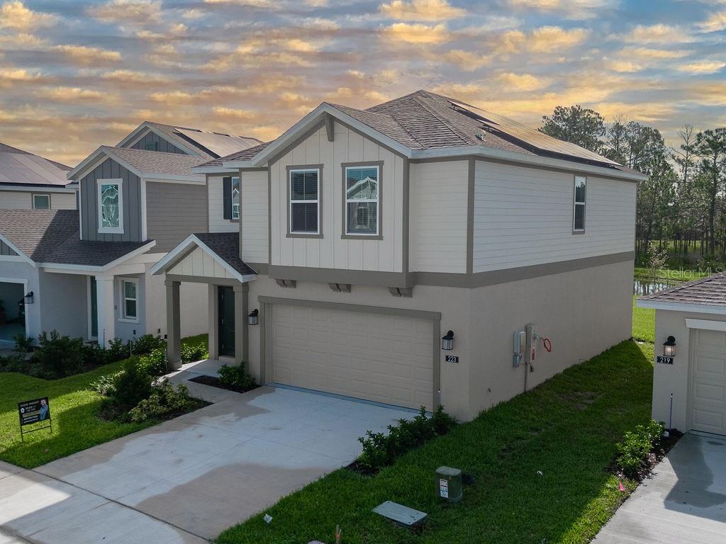 BEAUTIFUL LAKE VIEW! Astonia is a masterplan community of new single-family homes for sale in the fast-growing city of Davenport, FL. The construction of this beautiful single-family home is almost finished. Residents enjoy easy access to world-class theme parks. With four bedrooms, two and a half baths, this home offers an open floor plan with a great room, dining room, and kitchen with a large island. The kitchen features ample counter space and a generous pantry. The second floor includes an owner's retreat featuring an owner's bath with a large walk-in shower and a spacious walk-in closet. Three additional bedrooms, a bathroom, a spacious loft, and a laundry room finish off this beautiful home. This home comes fully equipped with new appliances, quartz countertops throughout, and tile flooring in the wet areas. The property comes unfurnished. Also, the house is equipped with solar panels, making it an environmentally-friendly and energy-efficient oasis.