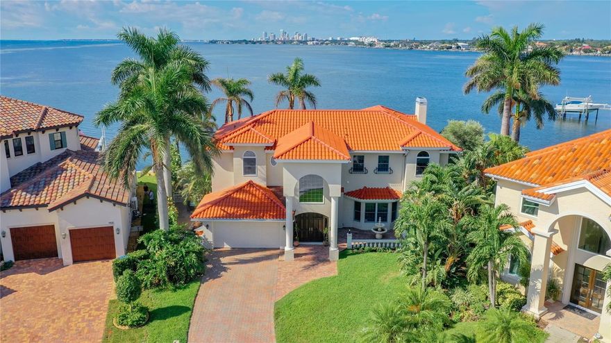 ~ Unparalleled LUXURY with UNOBSTRUCTED WATERFRONT property offering breathtaking vistas of TAMPA BAY and SKYWAY BRIDGE, DOWNTOWN ST. PETE and even Tropicana Field. This is not just a HOME, it's a sanctuary of opulence nestled in the best lot of coveted Venetian Isles. As you step through the double solid wood doors, the world beyond fades away, replaced by the mesmerizing OPEN BAY PANORAMA that greets you from every corner of this paradise cul-de-sac abode. Recently upgraded to perfection, this residence boasts a slew of new features, including a NEW ROOF WITH NEW BUILDING CODES (installed 8/2023), 3 NEW A/C UNITS (1-2018 2-2022) for all 3 zones, 2 NEW WATER HEATERS (2020), and NEW EXTERIOR PAINT (2022), ensuring both comfort and style. Even the garage door and springs were replaced in 2019, highlighting the meticulous care that has been poured into every aspect of this property. Step into the grand foyer with its cathedral ceilings, and you'll be immediately drawn towards the captivating waterfront scenes that beckon through expansive Wind RATED windows and SLIDING DOORS. Imagine waking up to the playfulness of dolphins, the grace of manatees, and the gentle dance of oceanic life, all visible from the comfort of your living space. The heart of this residence is undoubtedly the world-class Chef's kitchen, adorned with stunning granite countertops, GAS stove and complemented by elegant solid custom WOOD cabinets. Hosting gatherings becomes an art with a spacious MEDIA/GAME room, equipped with a wine fridge, sink, and an abundance of cabinetry for all your entertainment needs. And when the evening beckons for coziness, the Gas burning FIREPLACE in the family room sets the perfect ambiance for cherished moments with loved ones. Pool Bath with extra protection of Hurricane Shutter and outside wash area is the perfect way to get to the pool and make it convenient for your four-legged companions to join in the fun. A state-of-the-art dock with heat-reflective technology (2020) that's ready for your future boat lift. Whether it's fishing or simply enjoying the fireworks, this waterfront haven delivers it all. SALT WATER POOL resurfaced and updated with NEWER PUMP (2019), NEW POOL FILTER and retiled (2017) with EXQUISITE TRAVERTINE. PATIO (2020). NEW BALCONY (2021) provides yet another vantage point to take in the stunning surroundings. Smart LUTRON light switches offer modern convenience and could be controlled from your own mobile device. 6 NEW outdoor speakers creating an atmosphere of entertainment and relaxation. Indoors, LED lighting sets the tone of elegance while regal ironwood stairs will lead you to the bedroom quarters, where each room offers captivating WATER VIEWS. A BONUS UPSTAIRS OFFICE with FRENCH DOORS and office shelves. Laundry room with washer and dryer adds practicality to the mix. Enjoy swift access to Tampa International Airport, just 25-min drive. Downtown St. Petersburg, a mere 4-mile bike or GOLF cart ride, presents a vibrant tapestry of the Saturday morning market, diverse restaurants, boutique shopping, world-renowned art galleries including the Dali Museum, the Pier, John Hopkins Hospital, and private airport for your convenience. A+ schools Canterbury and SHORECREST and our World famous Beaches and Yacht Clubs. Just a few miles from your grocery needs Fresh Market, Trader Joes, Rolling Oats, Publix, and coming soon new Whole Foods. This residence is more than just a home; it's your FLORIDA DREAM realized!