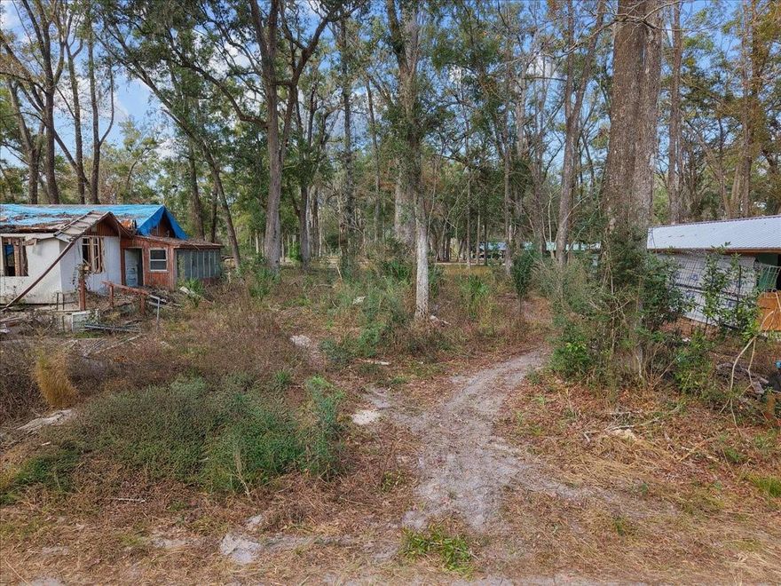 Perfect 3.26 acres located in gorgeous Dixie County. This property has an home that would require demo, a detached carport and shed as well and a 50x14 barn! Metal is there to wrap barn! Property has well (just need pump and air tank), power pole (not active) and septic in place. Property being sold AS IS only, with all items conveying .What a unique opportunity to make this place yours , a great property and location for YOUR dream home! Site built and manufactured homes allowed! Call today!