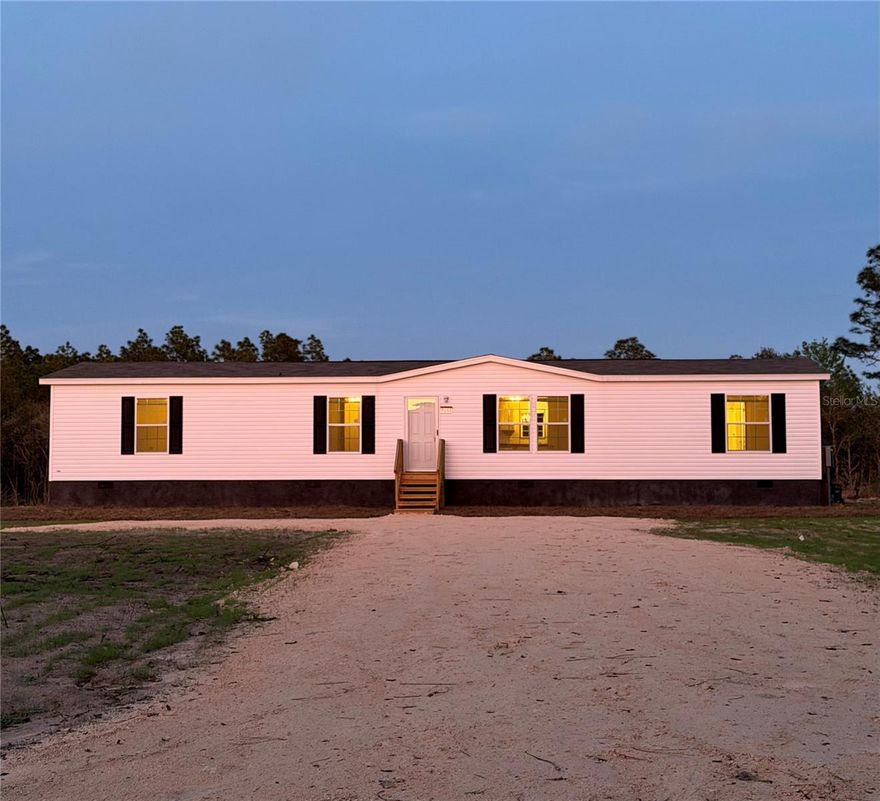 One or more photo(s) has been virtually staged. HUGE PRICE IMPROVEMENT! Brand New 2026 mobile home with 4 bedrooms, 2 bathrooms, and 1,813 sq.
Features include FHA/VA-compliant stucco skirting with venting, new septic, well, underground electric, planted grass, sod, and fiber availability. 
Located on a 1.25-acre corner lot with a split bedroom layout and no HOA. 
30 minutes from Gainesville and 40 minutes from Ocala.